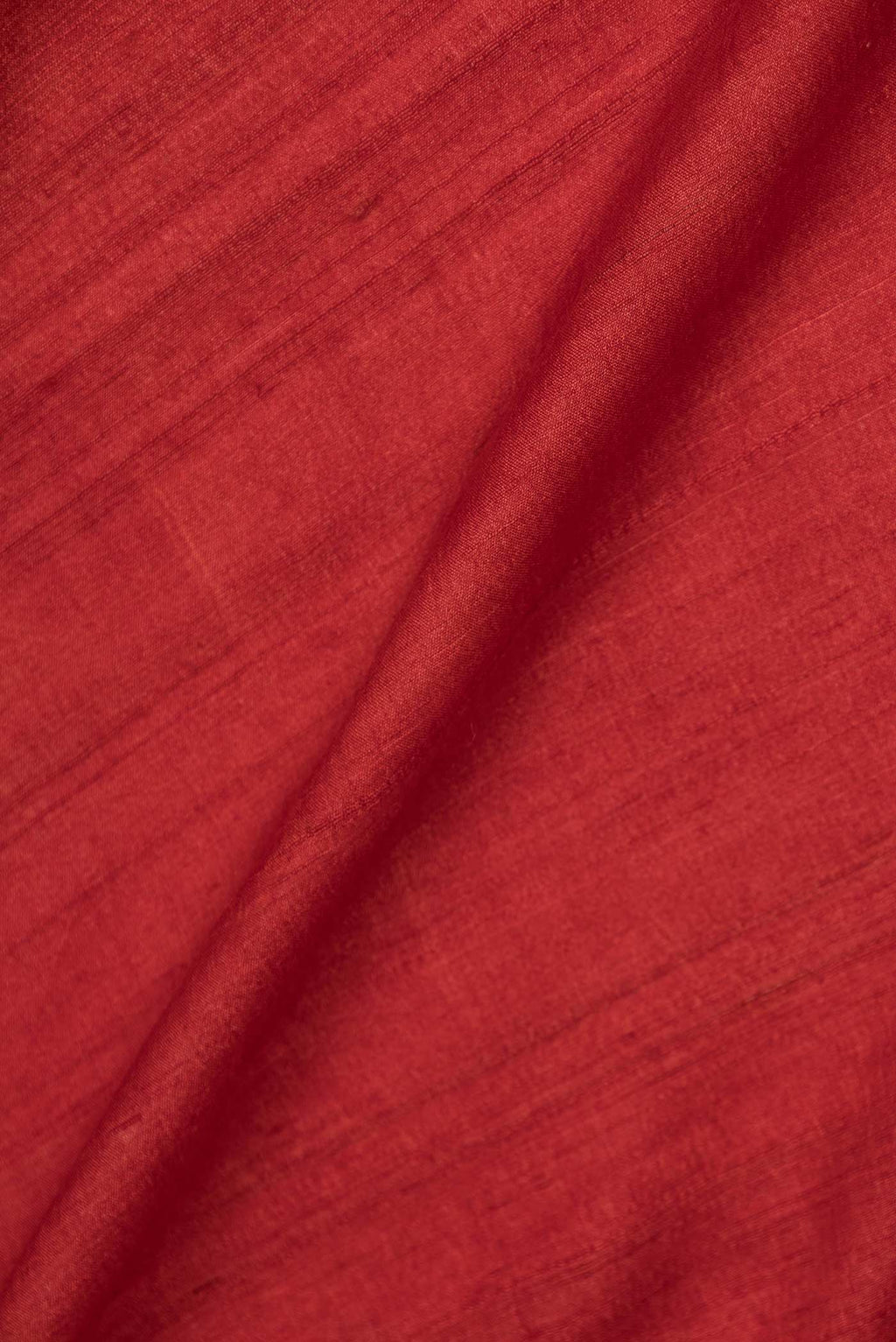 Close up of Orange Dual Tone Tussar Saree with Plain Body and Embroidery Border displaying folds