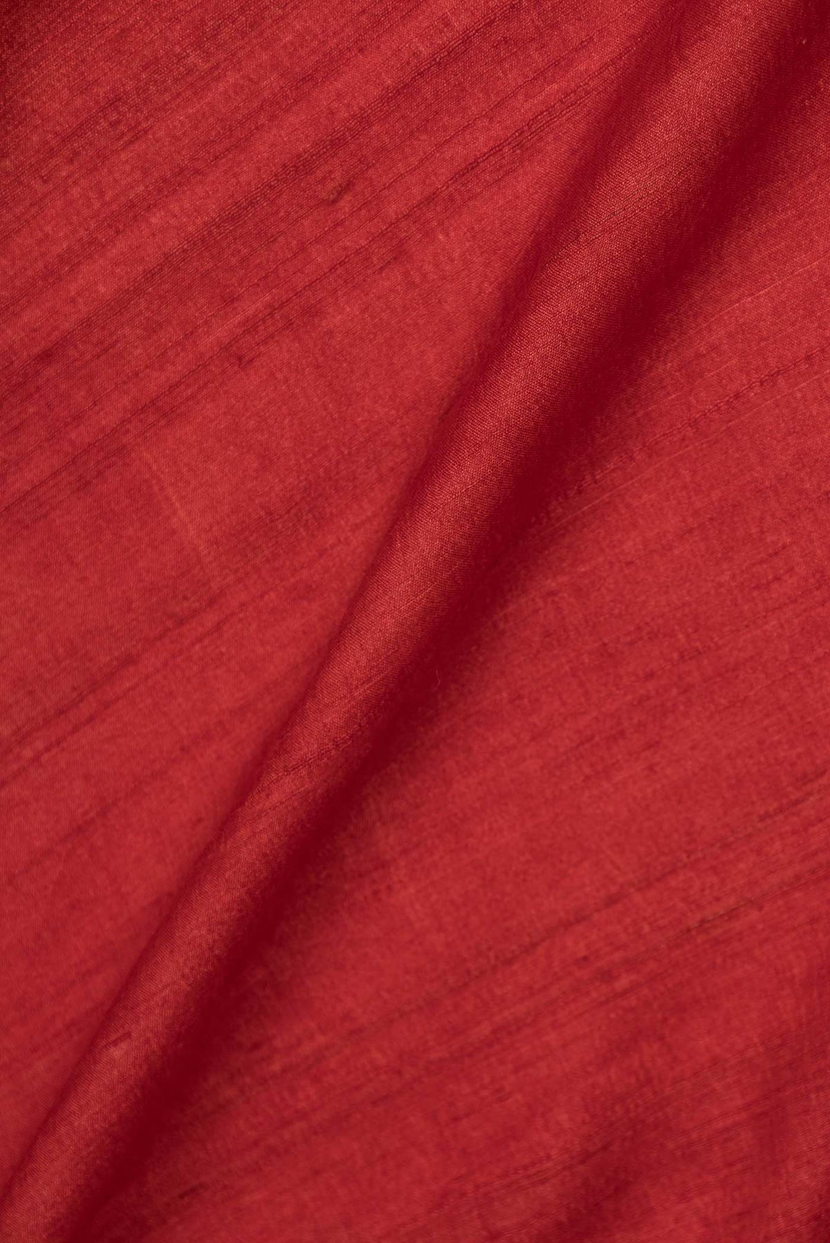 Close up of Orange Dual Tone Tussar Saree with Plain Body and Embroidery Border displaying folds
