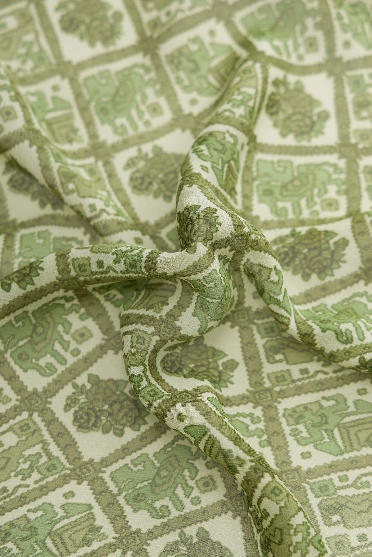 Close up of Green Dual Tone Mysore Crepe Saree with Printed design on the body and Printed Border.  displaying folds