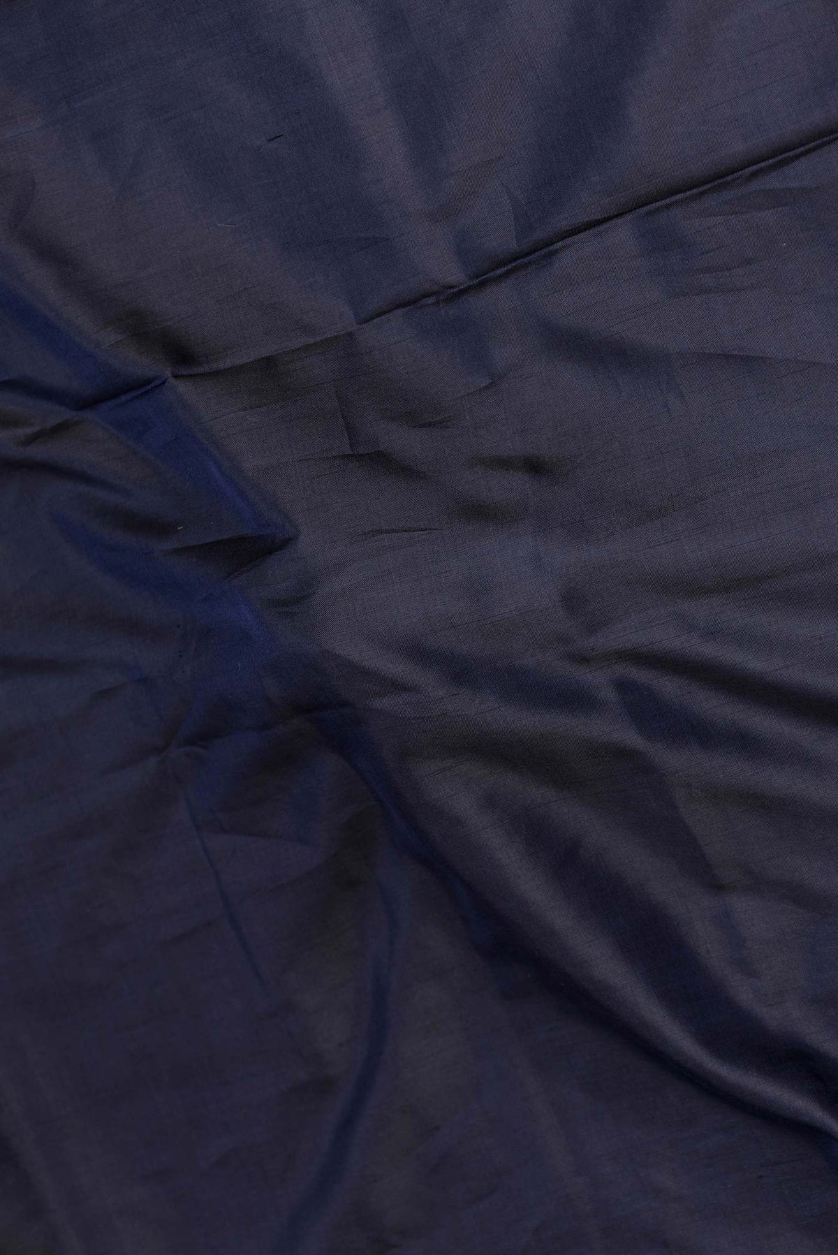 Close up of Navy Blue Dual Tone Banarasi Saree with Plain Body and Fancy Border displaying folds