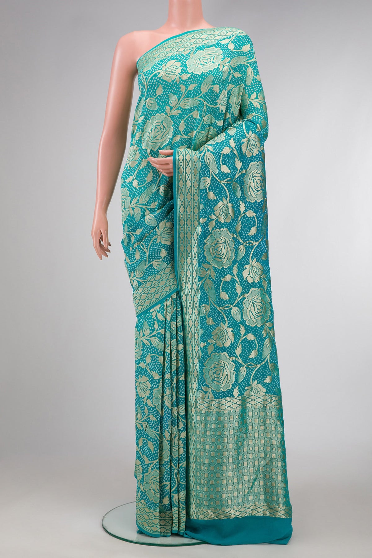 Sky Blue Dual Tone Bandhani Silk Saree with Bandhani Print on the body and Zari Border.  displayed on a mannequin