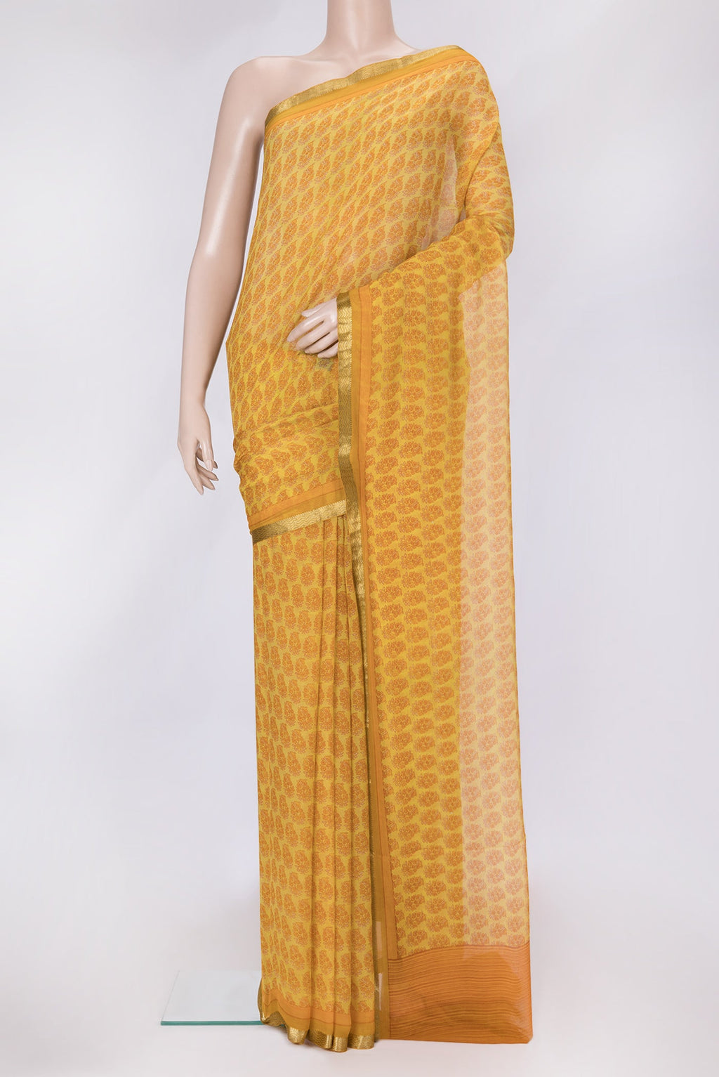 Mustard Dual Tone Mysore Chiffon Saree with Printed design on the body and Zari Border.  displayed on a mannequin