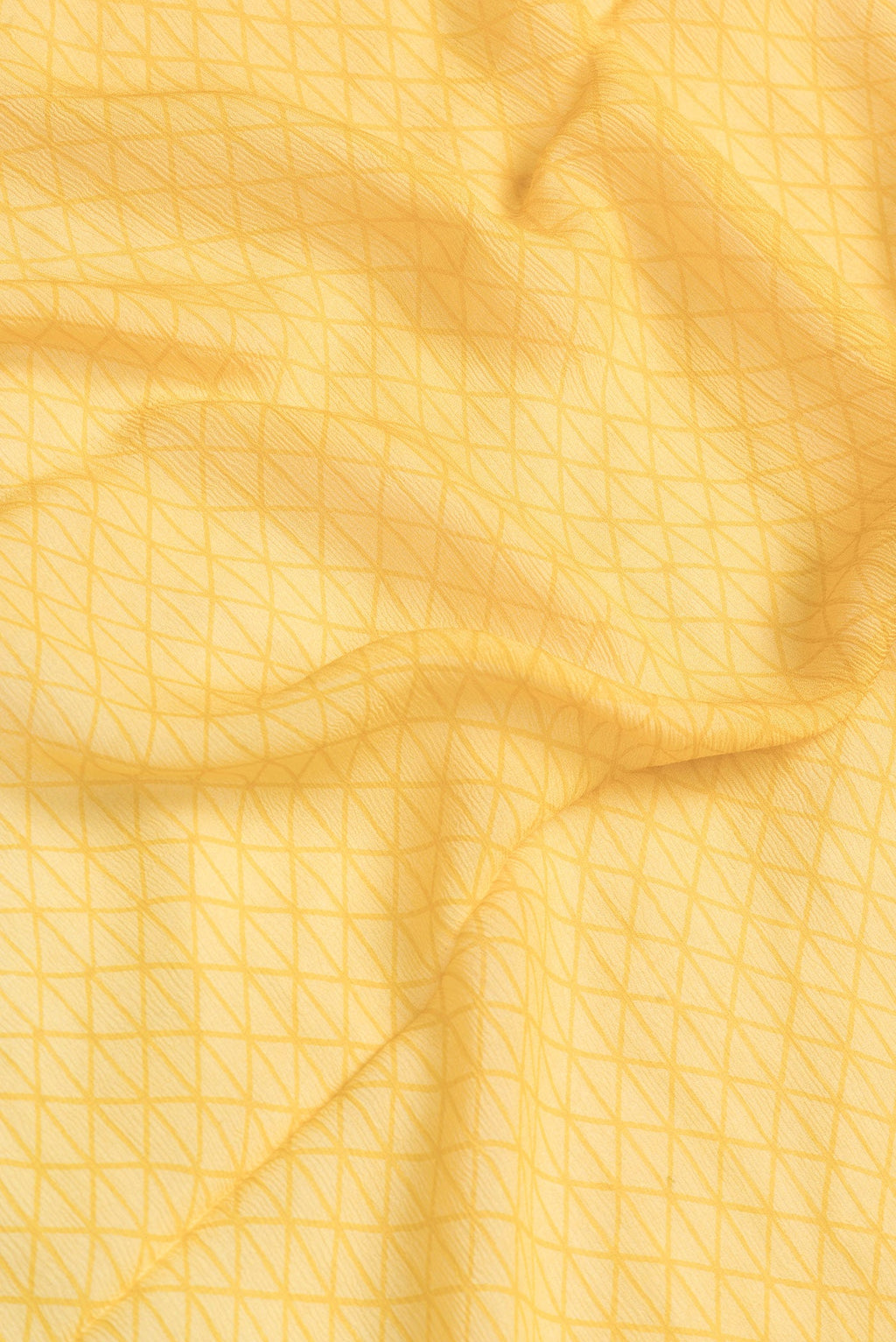 Close up of Mustard Dual Tone Mysore Chiffon Saree with Printed design on the body and Fancy Border.  displaying folds