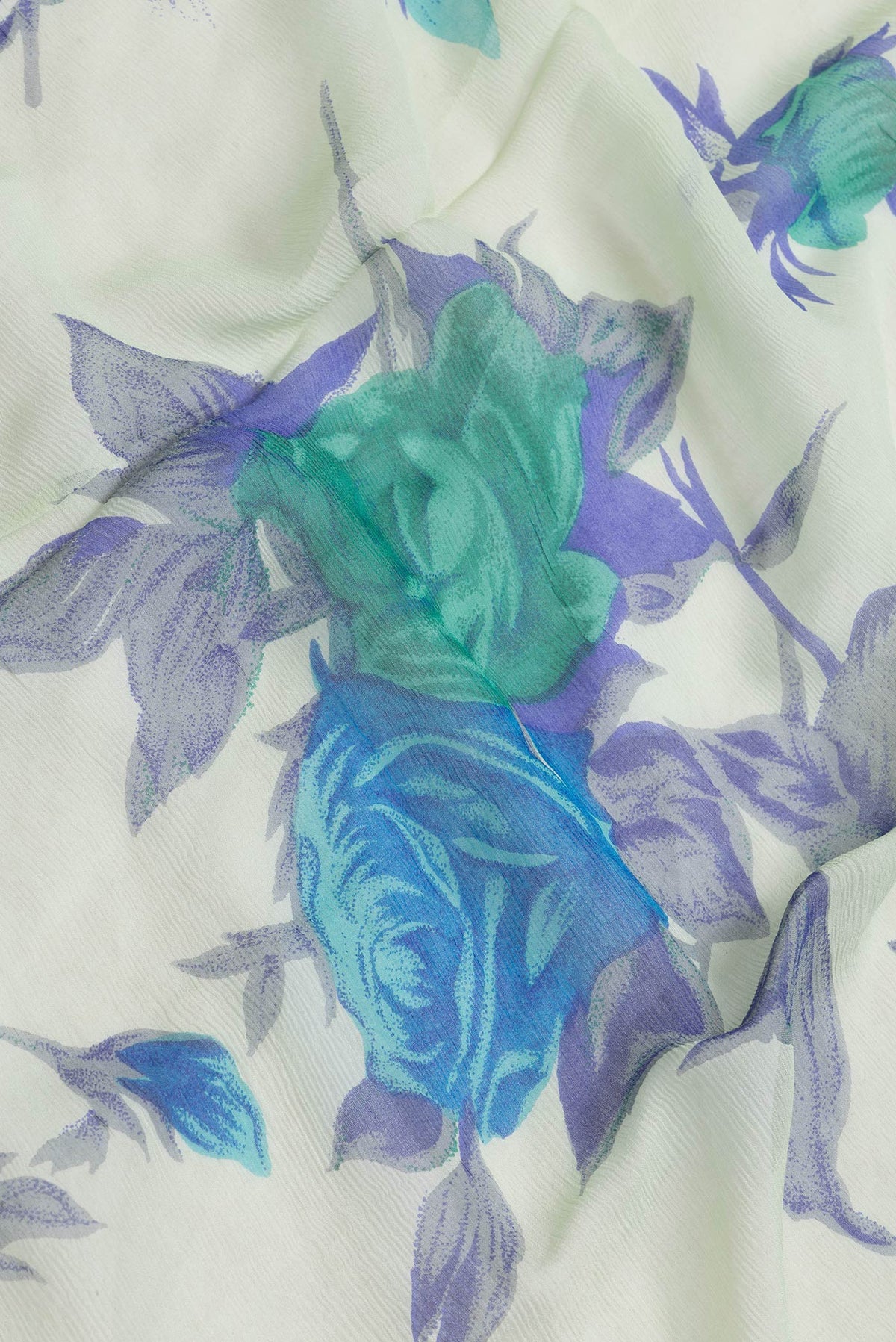 Close up of Pista Green Dual Tone Mysore Chiffon Saree with Printed design on the body and Zari Border.  displaying folds