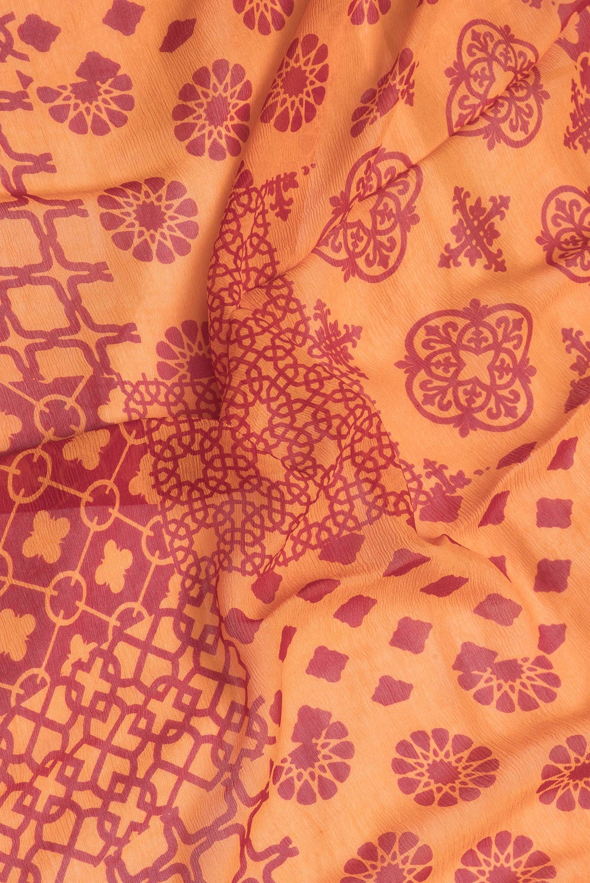 Close up of Orange Dual Tone Chiffon Saree with Printed design on the body and Checks Border.  displaying folds