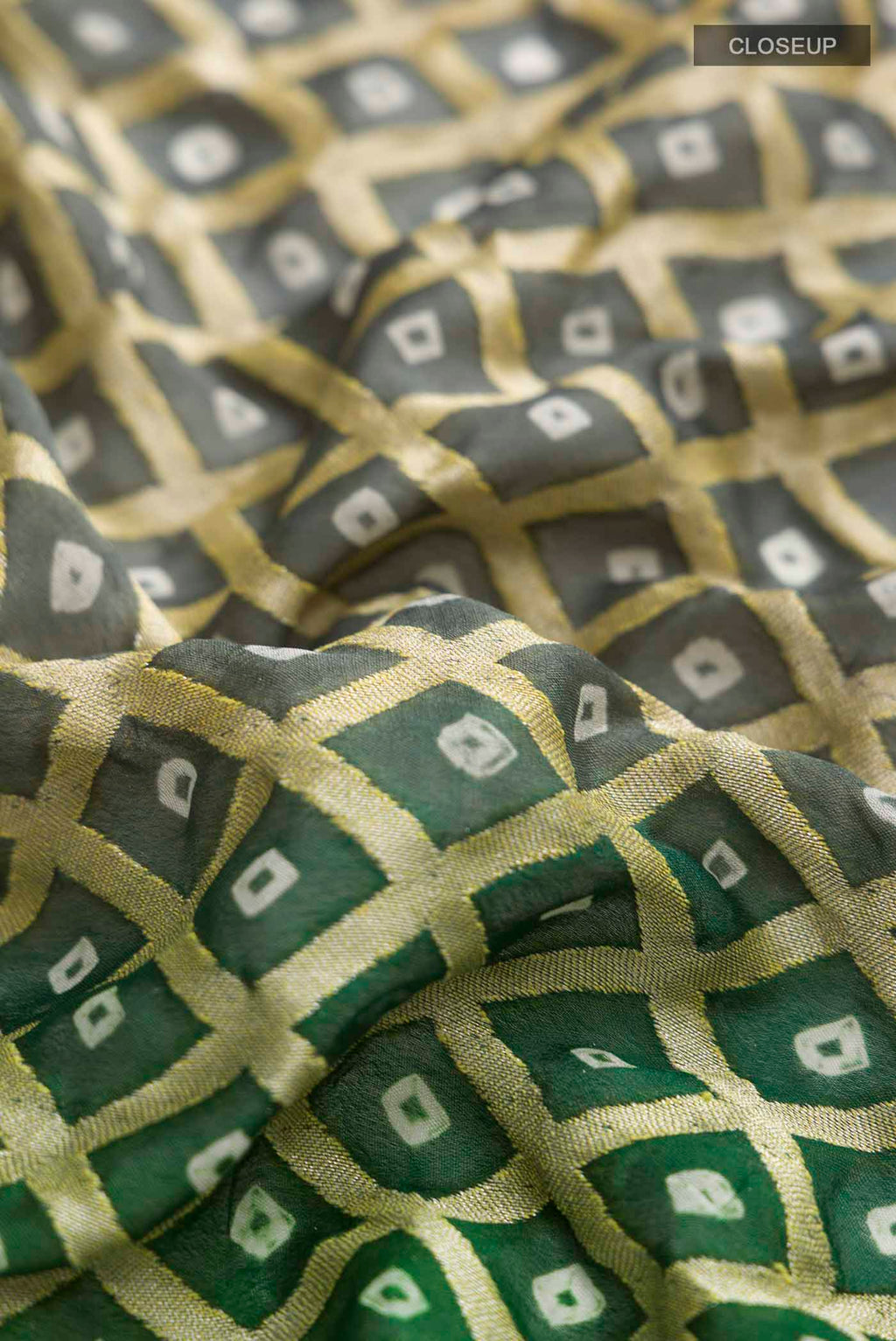 Close up of Green Banarasi Georgette Saree with Zari Butta on the body and Zari Border displaying folds