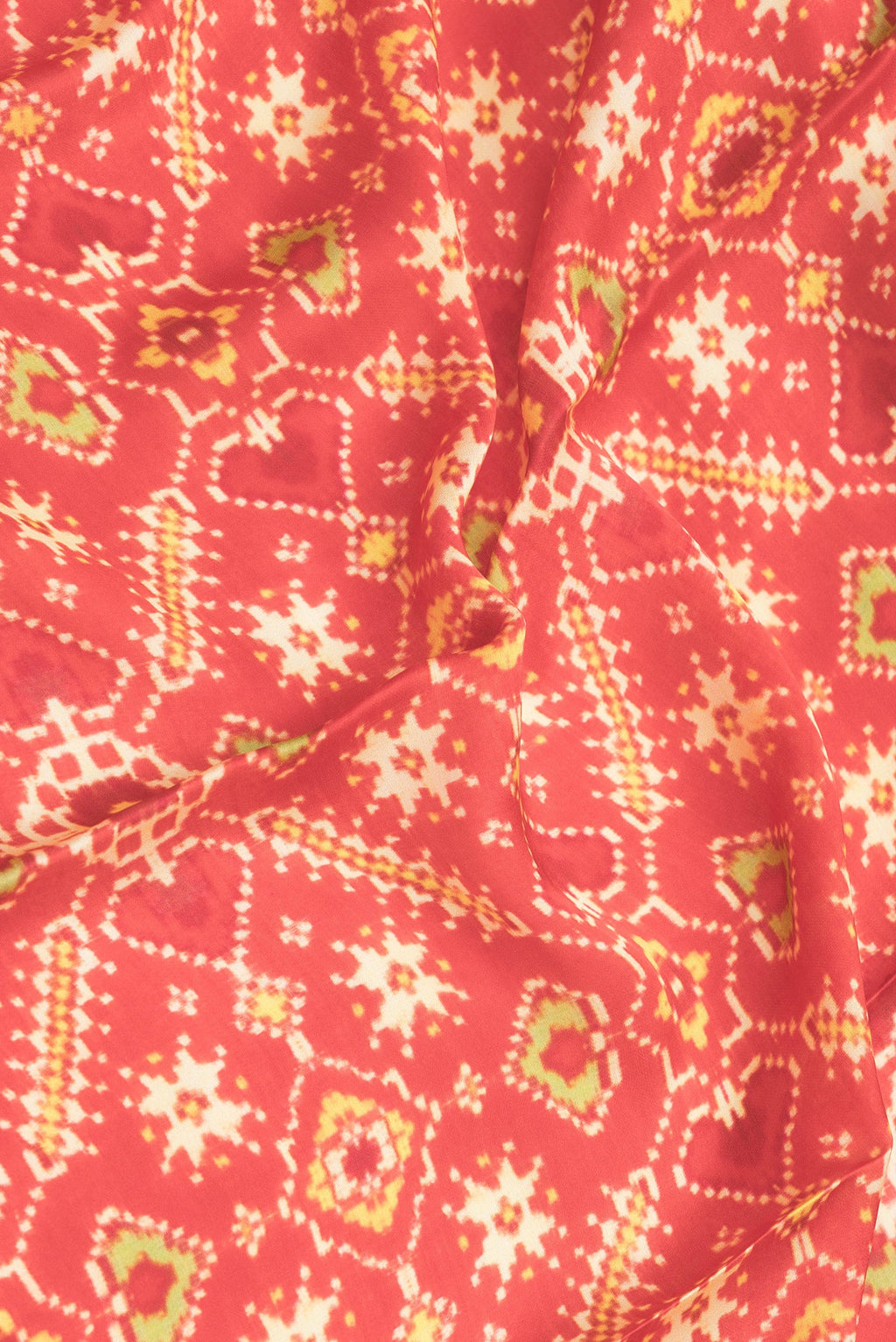 Close up of Red Dual Tone Mysore Crepe Saree with Printed design on the body and Printed Border.  displaying folds