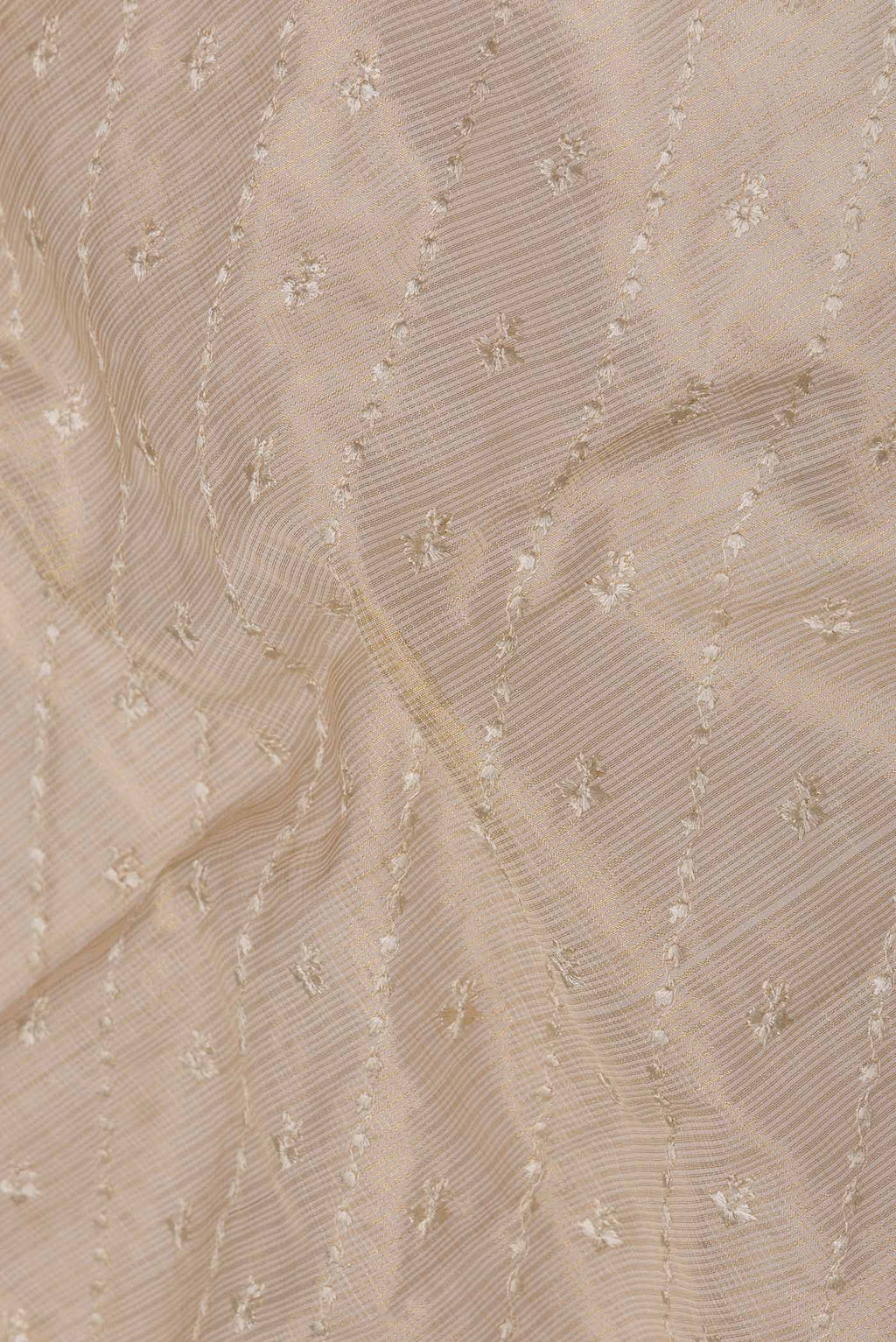 Close up of Beige Dual Tone Kota Silk Saree with Embroidery on the body and Zari Border displaying folds