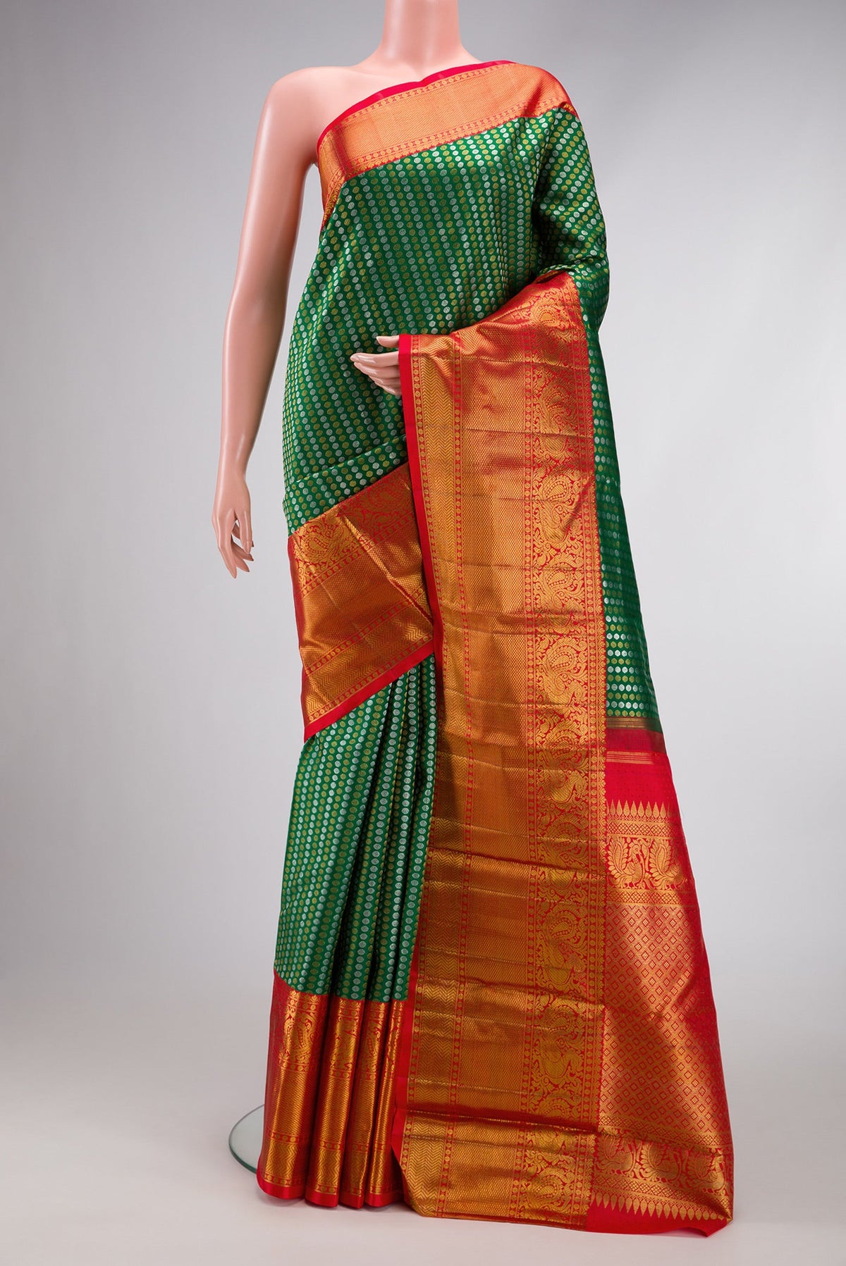 Green Kanjivaram Silk Saree with Zari Brocade on the body and Zari Border.  displayed on a mannequin