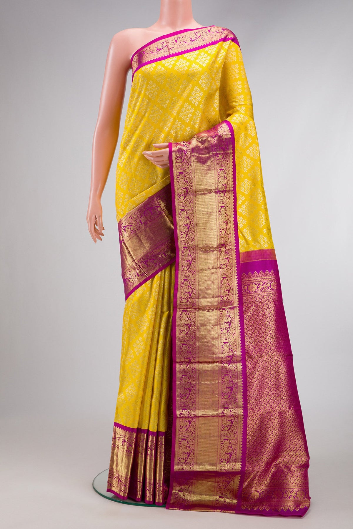 Yellow Dual Tone Kanjivaram Silk Saree with Zari Brocade on the body and Zari Border.  displayed on a mannequin