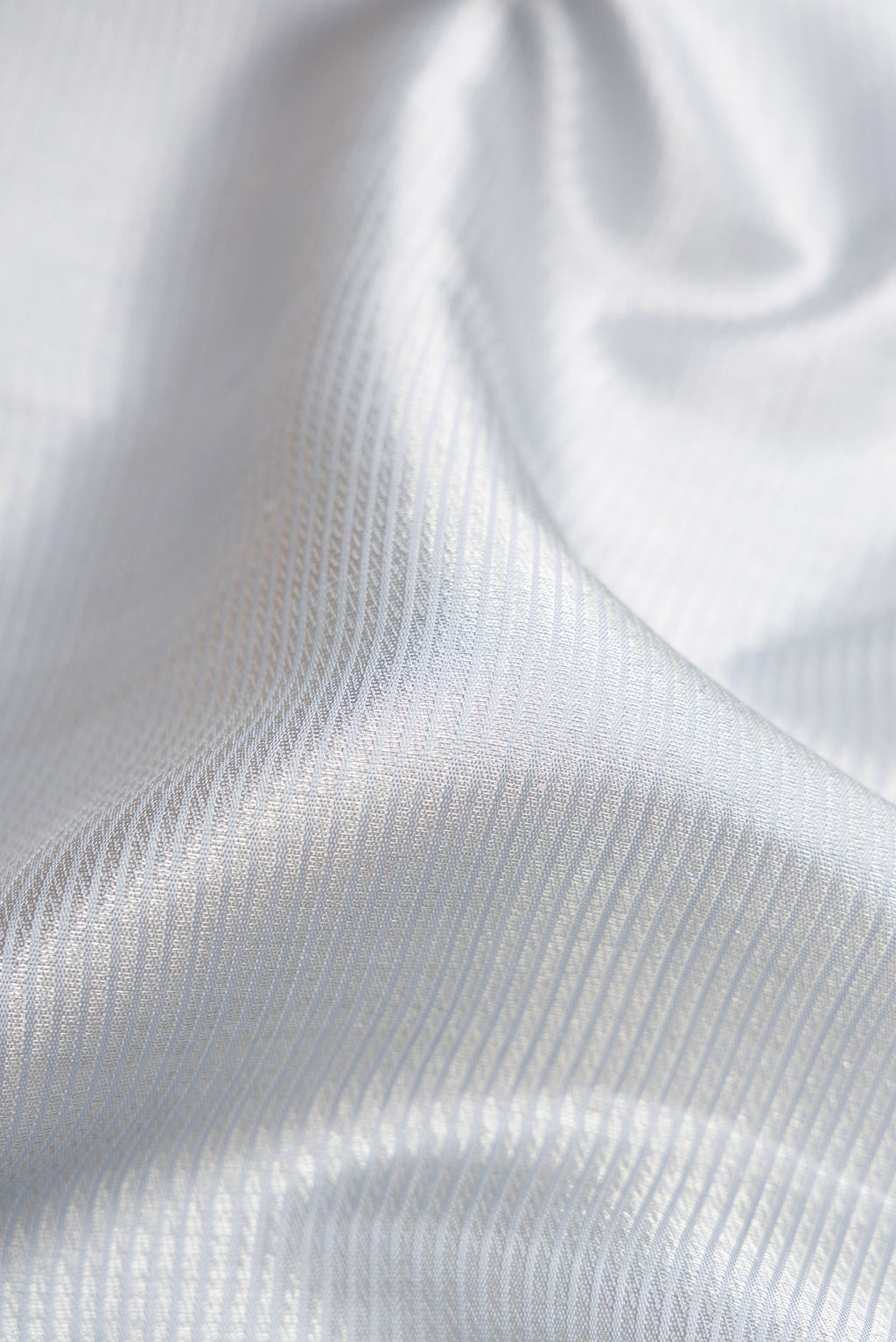 Close up of Grey Dual Tone Kanchipuram Silk Saree with Zari Brocade on the body and Zari Border.  displaying folds