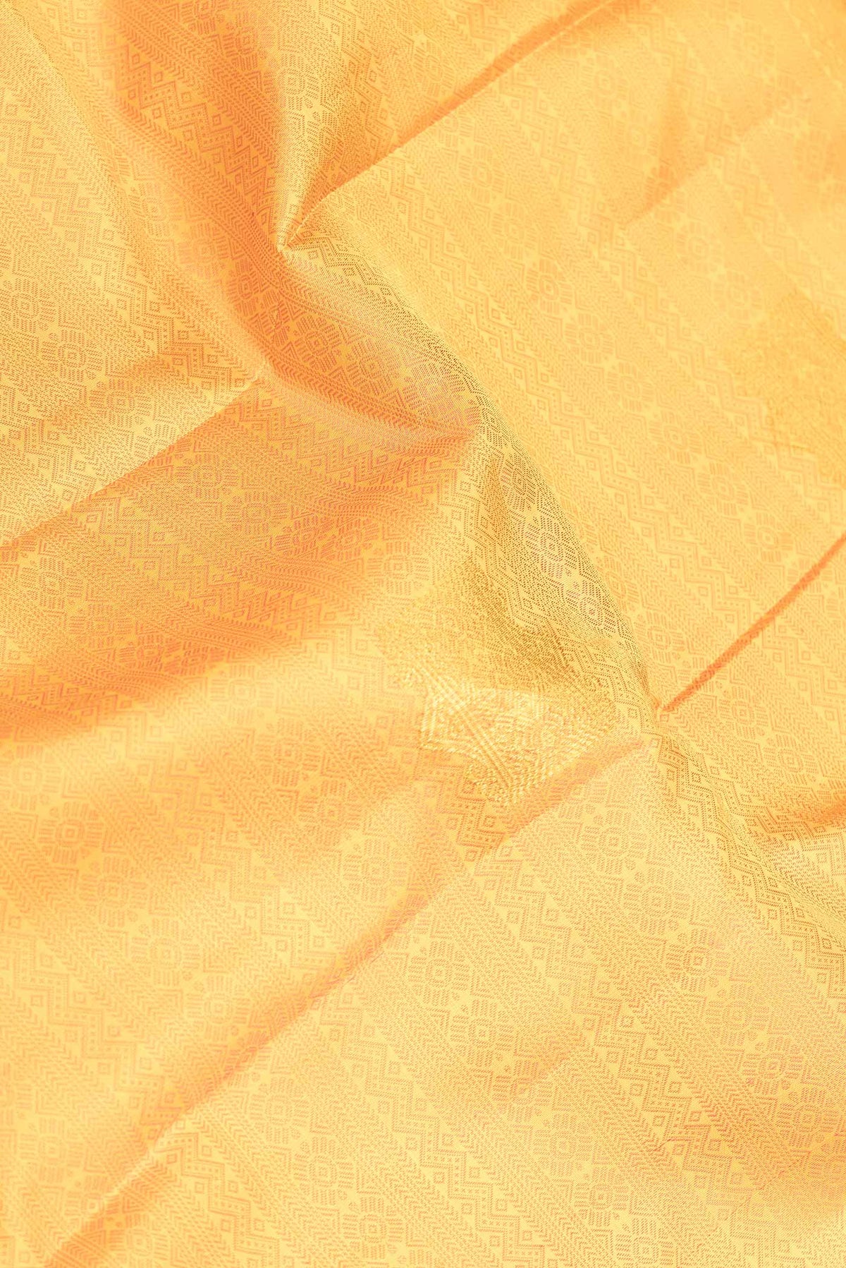 Close up of Yellow Dual Tone Kanchipuram Silk Saree with Jacquard With Zari Butta on the body and Zari Border displaying folds