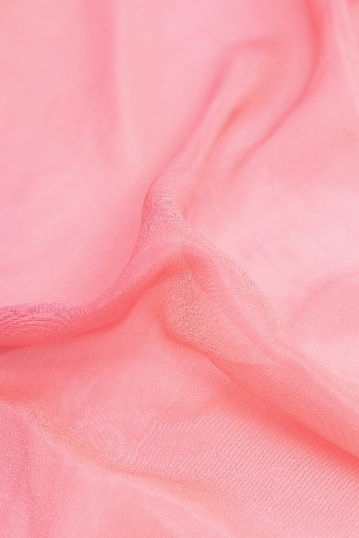 Close up of Pink Dual Tone Mysore Georgette Saree with Plain Body and Thread Border.  displaying folds