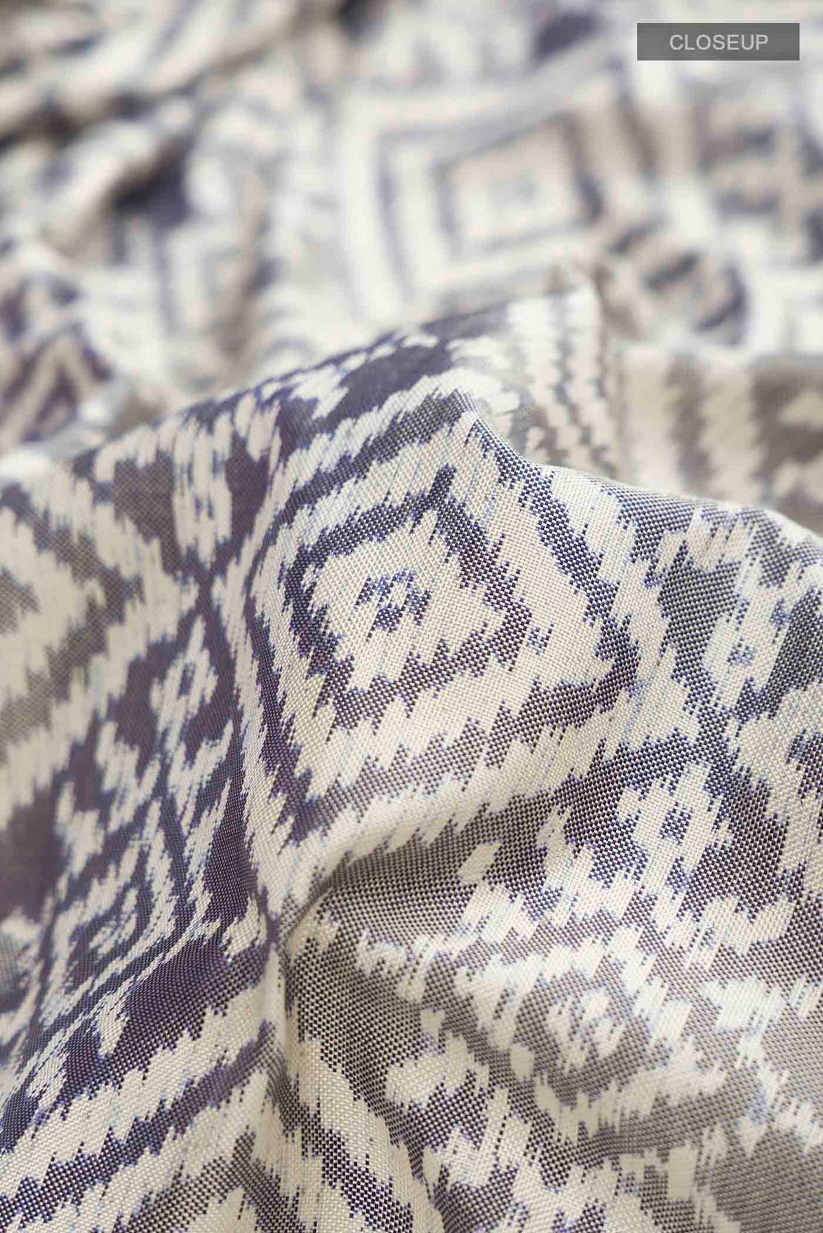 Close up of Grey Rajkot Patola Silk Saree with Pure Ikat on the body and Plain Border displaying folds