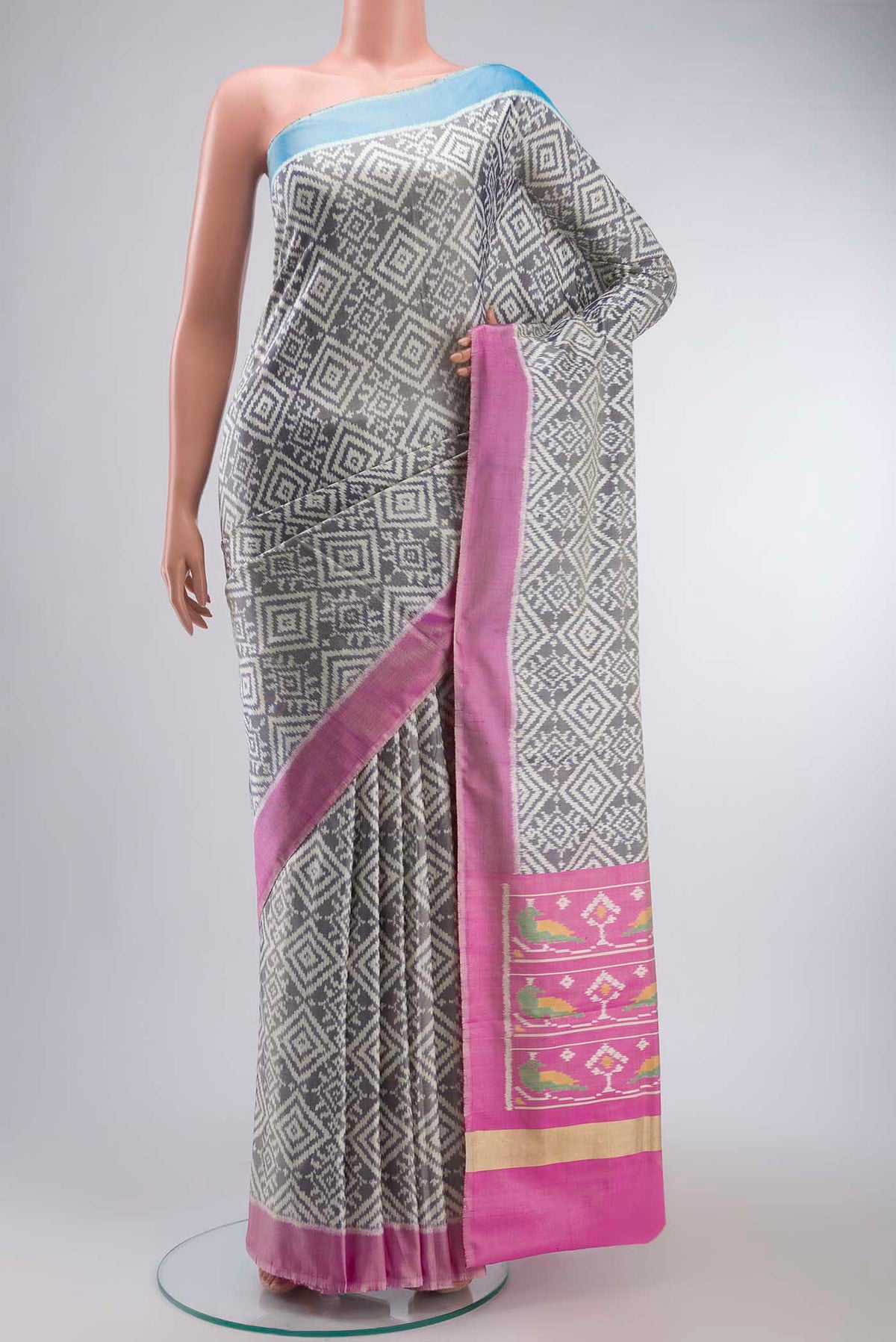 Grey Rajkot Patola Silk Saree with Pure Ikat on the body and Plain Border displayed on a mannequin