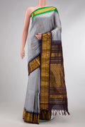 Grey Dual Tone Gadwal Silk Saree with Zari And Thread Butta on the body and Ganga Jamuna Border.  displayed on a mannequin