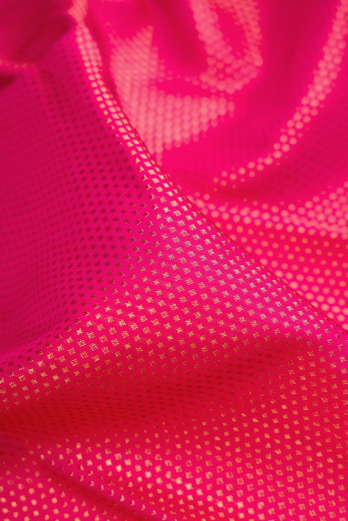 Close up of Pure Silk Pure Zari Pink Dual Tone Kanjivaram Saree with Zari Brocade on the body and Zari Border.  displaying folds