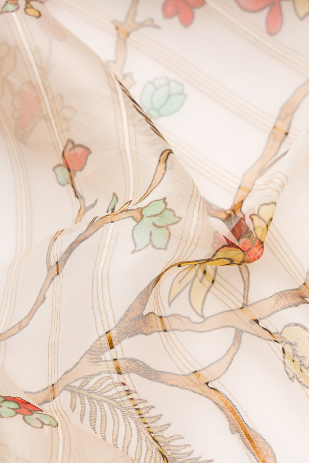 Close up of Beige Dual Tone Organza Silk Saree with Printed design on the body and Embroidery Border.  displaying folds