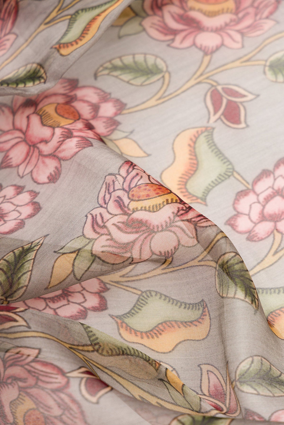 Close up of Grey Dual Tone Organza Silk Saree with Printed design on the body and Embroidery Border.  displaying folds