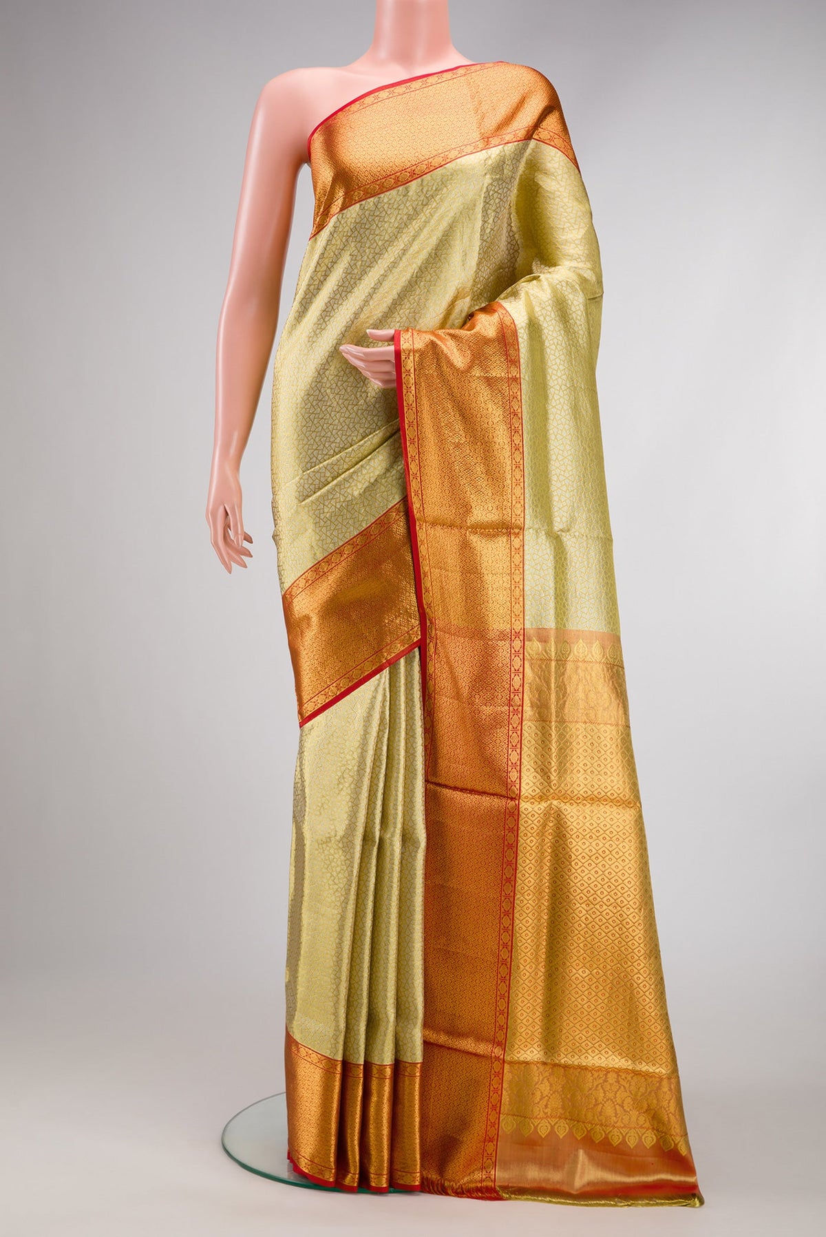 Gold Dual Tone Kanchipuram Tissue Silk Saree with Zari Brocade on the body and Zari Border.  displayed on a mannequin