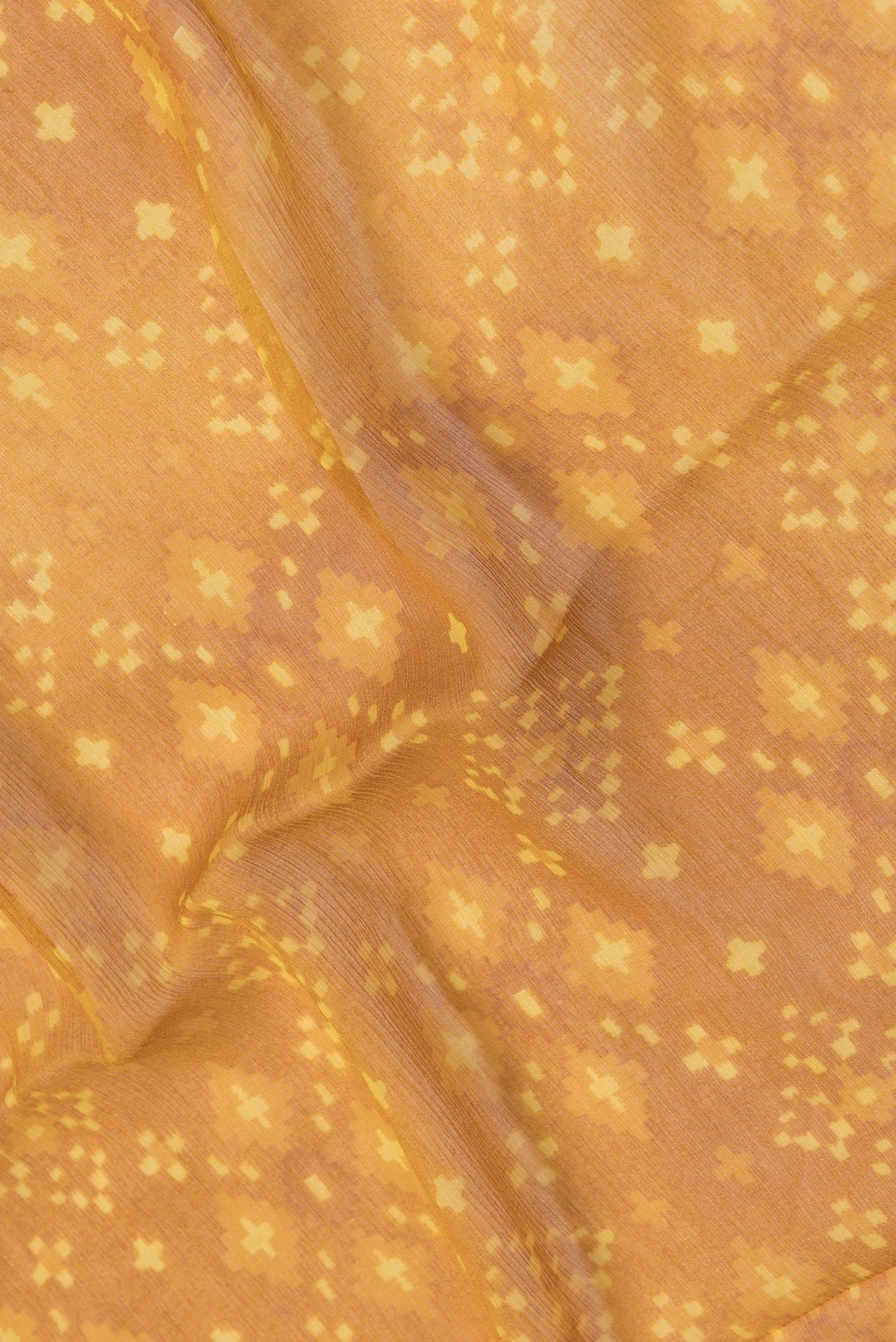 Close up of Mustard Dual Tone Mysore Chiffon Saree with Printed design on the body and Plain Border.  displaying folds