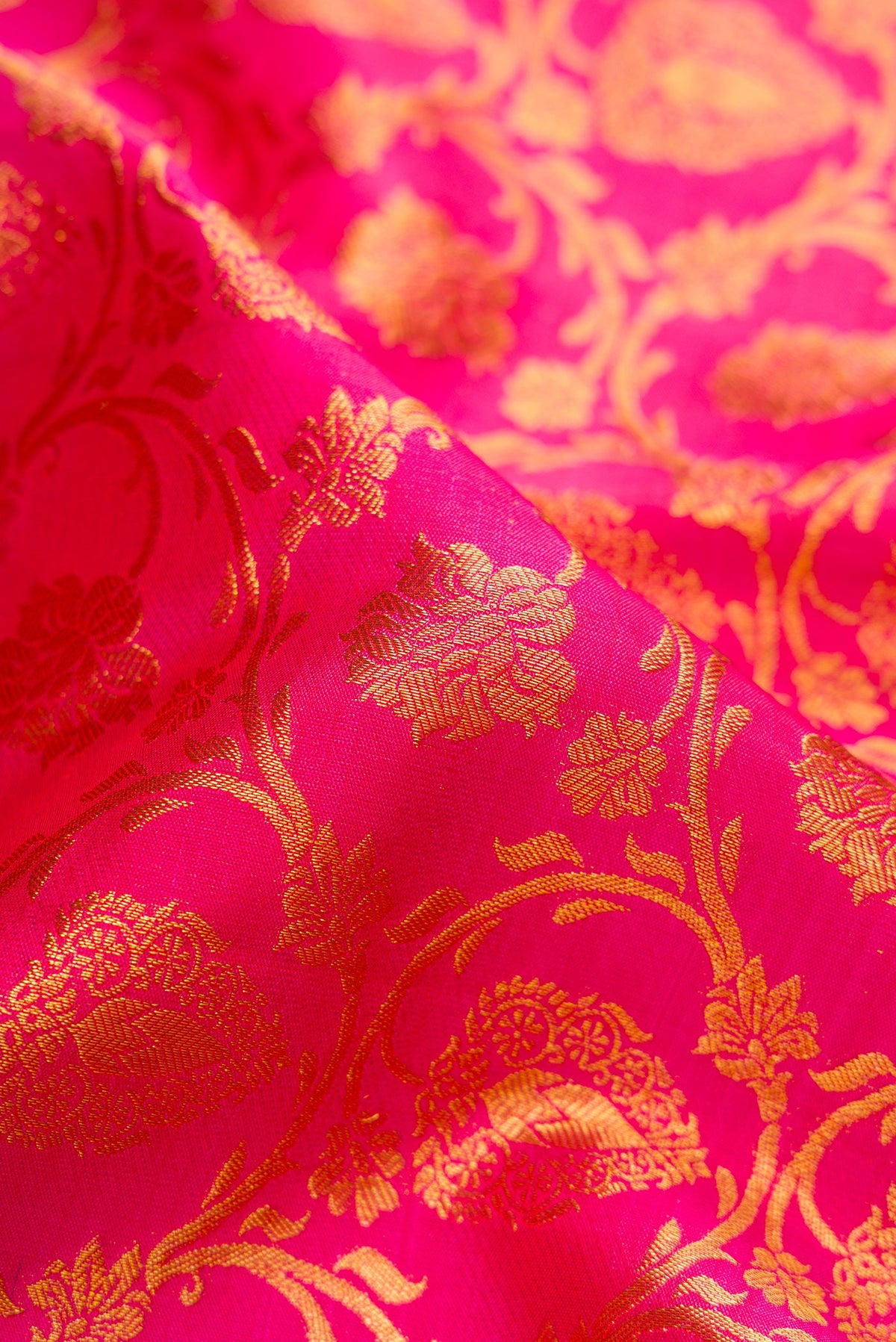 Close up of Pink Dual Tone Kanjivaram Silk Saree with Zari Brocade on the body and Zari Border.  displaying folds