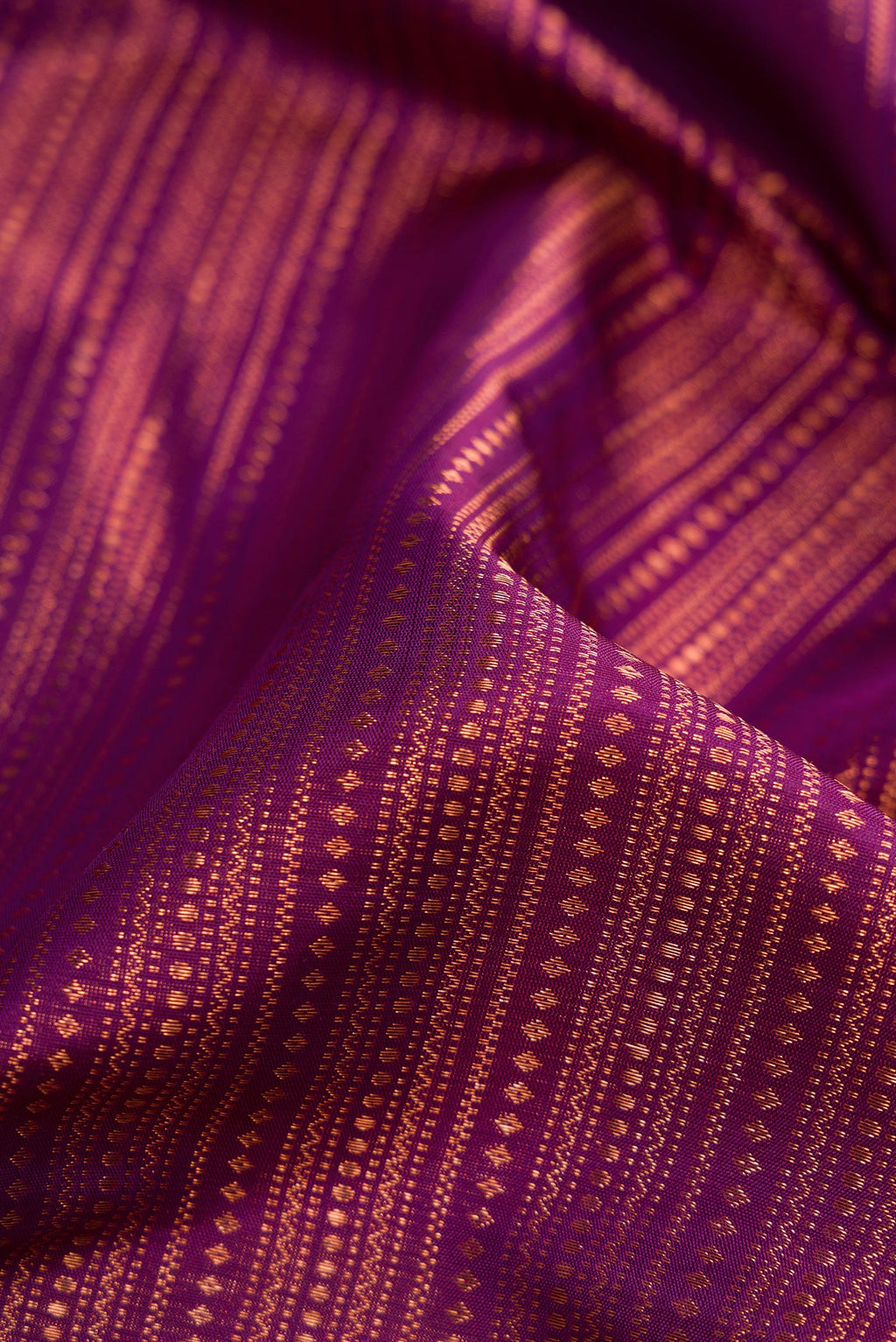 Close up of Purple Dual Tone Kanjivaram Silk Saree with Zari Brocade on the body and Fancy Border.  displaying folds