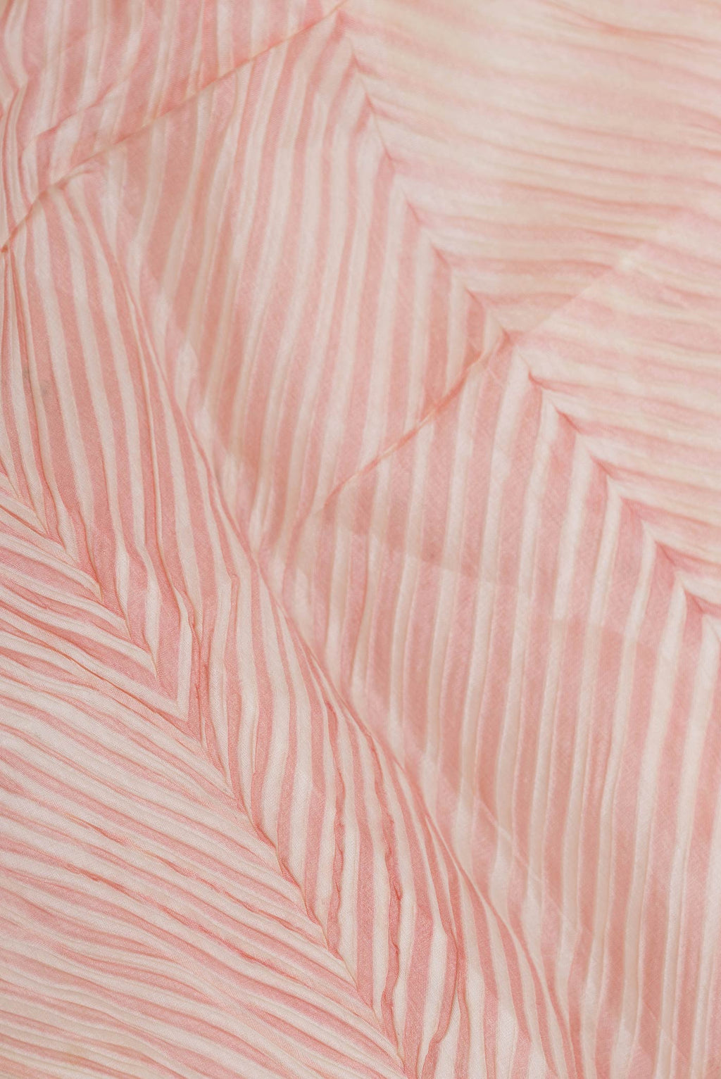 Close up of Pink Dual Tone Tussar Saree with Printed design on the body and Zari And Thread Border displaying folds