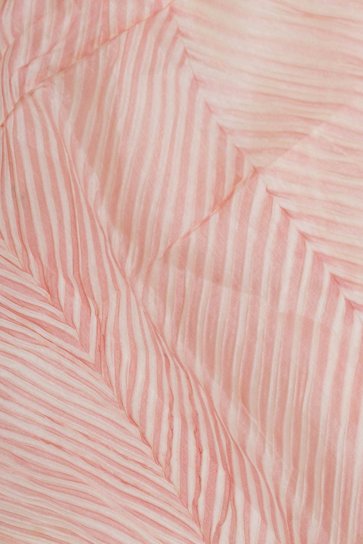 Close up of Pink Dual Tone Tussar Saree with Printed design on the body and Zari And Thread Border displaying folds