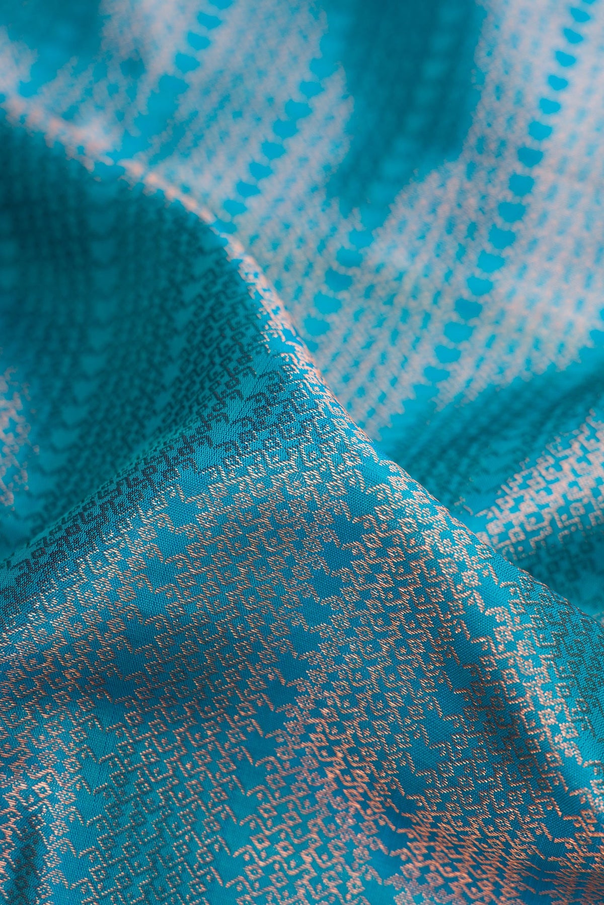 Close up of Peacock Blue Dual Tone Kanjivaram Silk Saree with Zari Brocade on the body and Fancy Border.  displaying folds