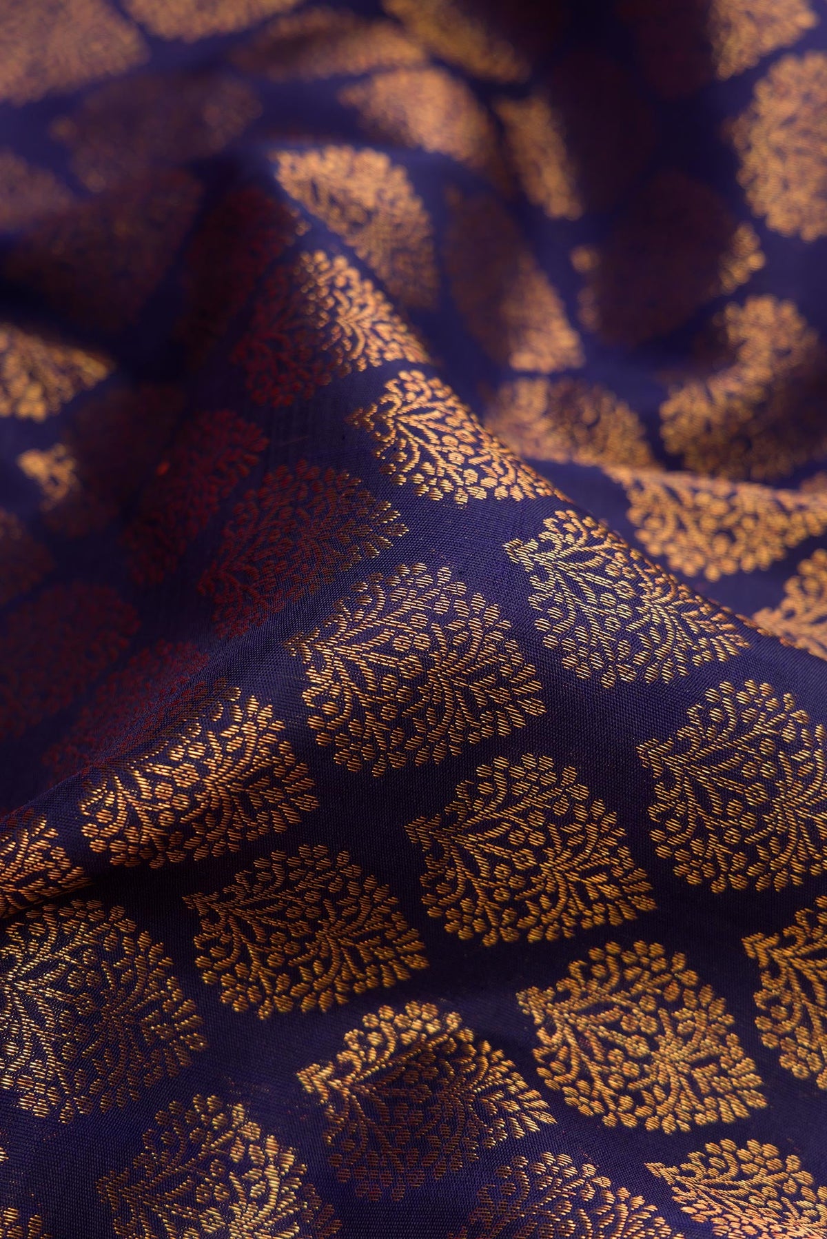 Close up of Navy Blue Dual Tone Kanchipuram Silk Saree with Zari Brocade on the body and Zari Border.  displaying folds
