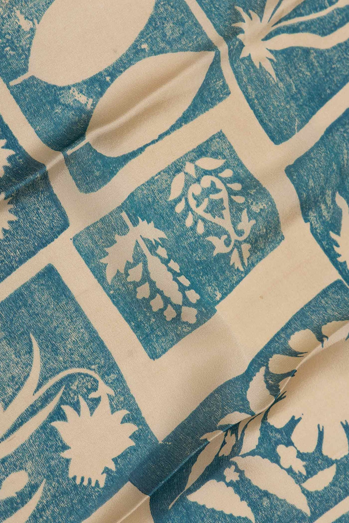 Close up of Green Dual Tone Mysore Crepe Saree with Printed design on the body and Zari Border displaying folds