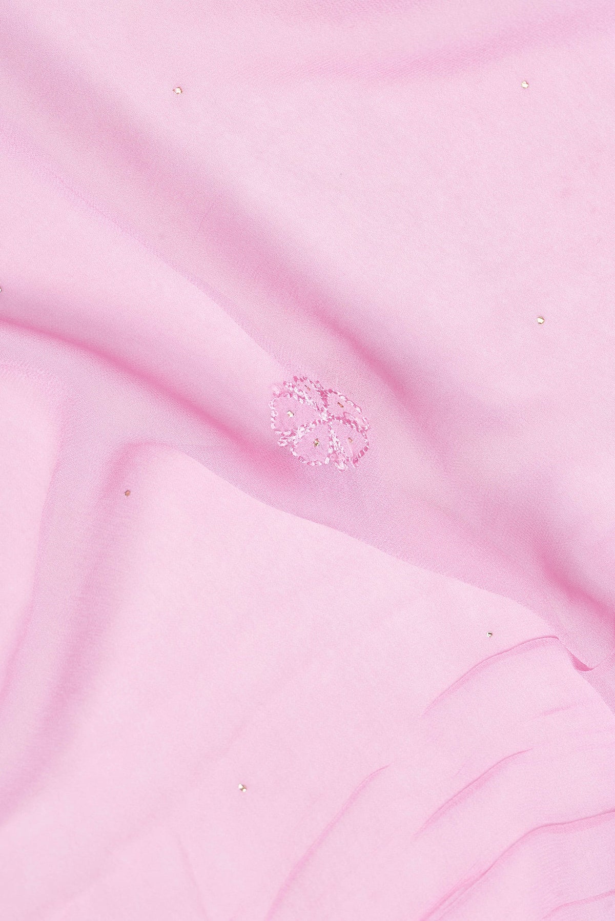 Close up of Pink Dual Tone Georgette Saree with Embroidery on the body and Embroidery Border.  displaying folds
