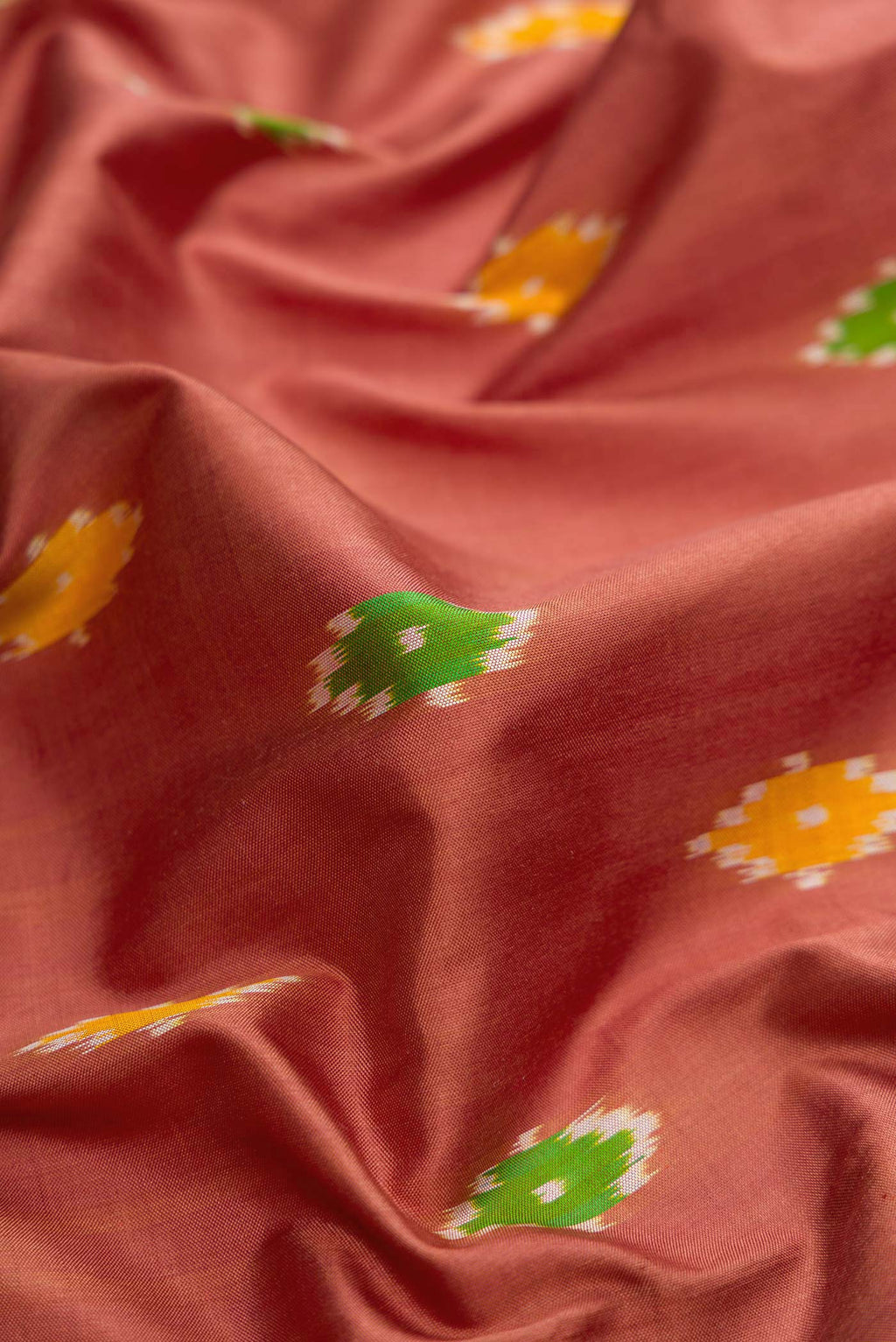 Close up of Brown Dual Tone Double Ikat Saree with Ikat Print on the body and Ikat Border.  displaying folds