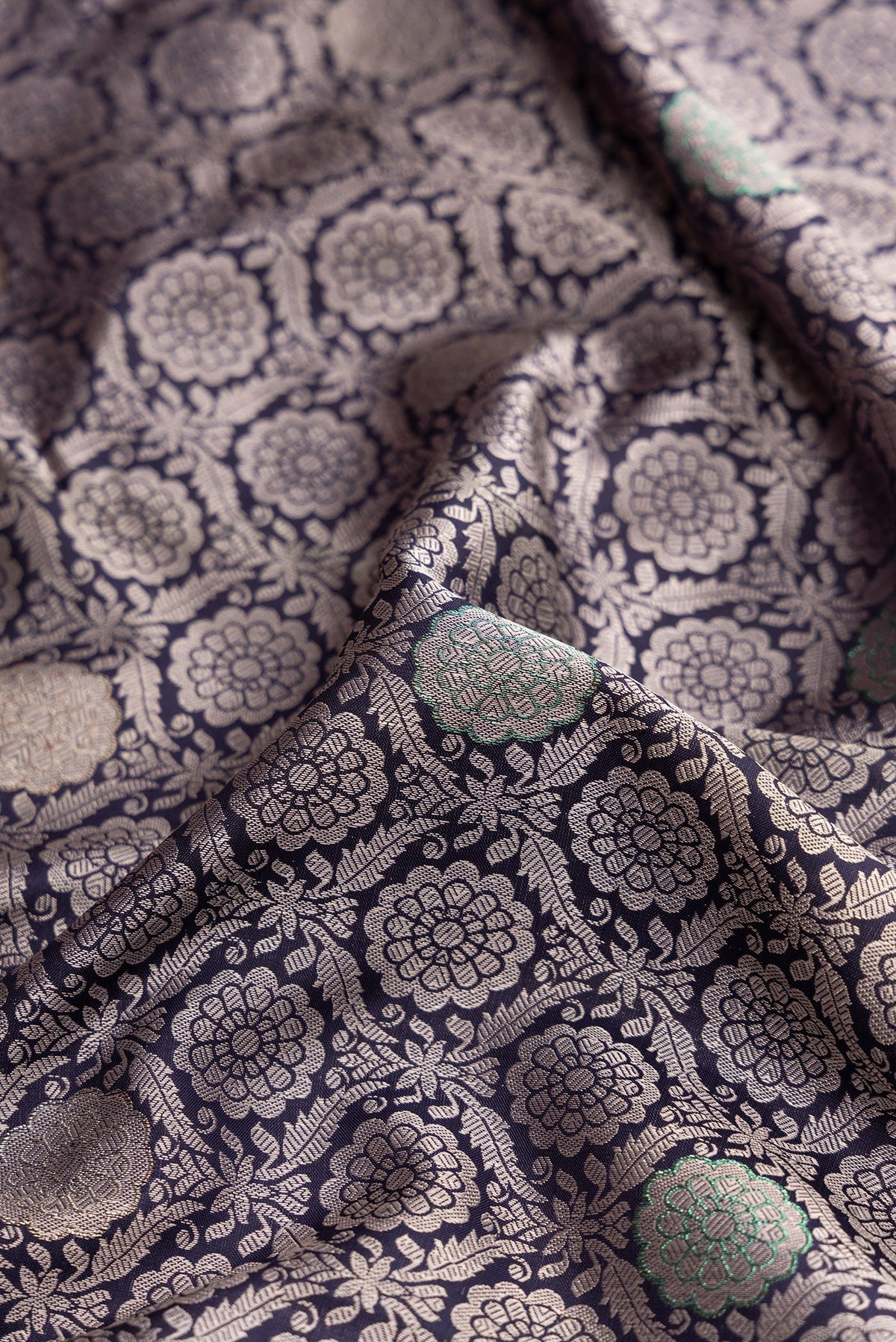 Close up of Navy Blue Kanjivaram Silk Saree with Jacquard With Zari Butta on the body and Zari Border.  displaying folds