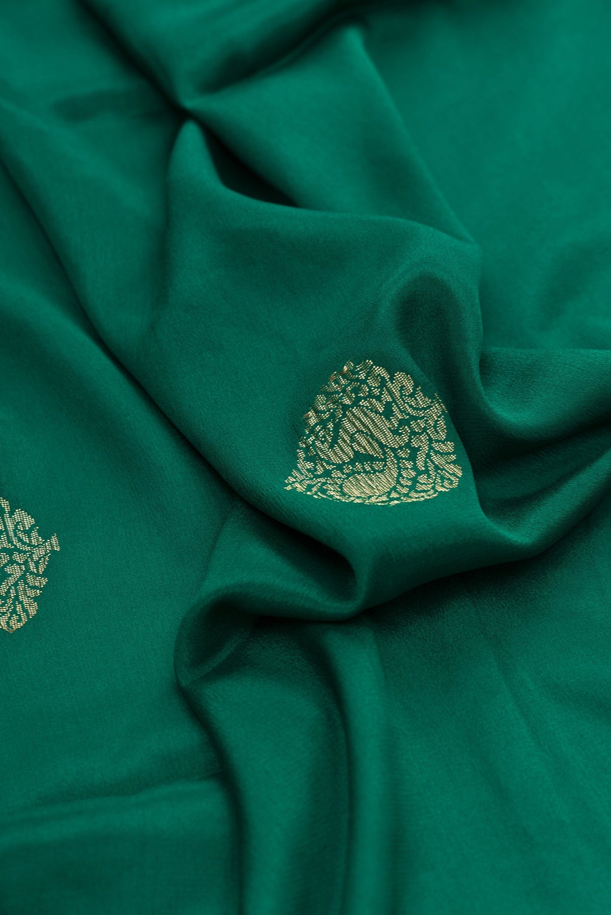 Close up of Bottle Green Dual Tone Mysore Georgette Saree with Zari Butta on the body and Zari Border.  displaying folds