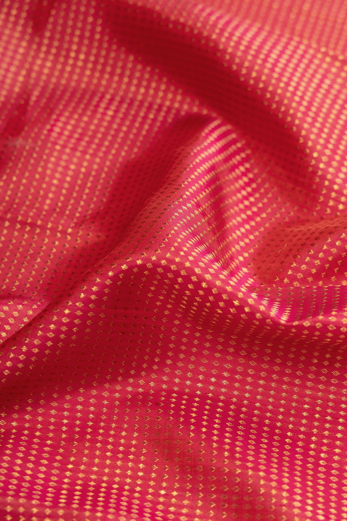 Close up of Dark Pink Dual Tone Kanjivaram Silk Saree with Stripes on the body and Zari Border.  displaying folds
