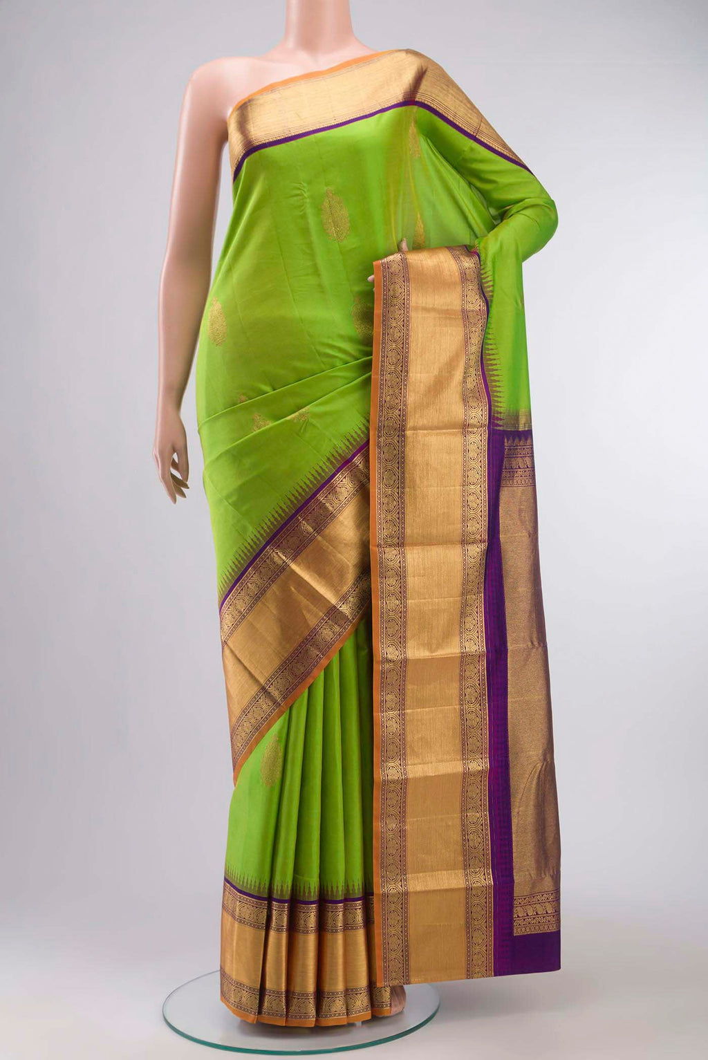 Green Kanchipuram Silk Saree with Zari Butta on the body and Zari Border displayed on a mannequin
