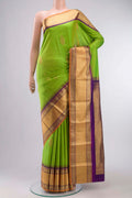 Green Kanchipuram Silk Saree with Zari Butta on the body and Zari Border displayed on a mannequin