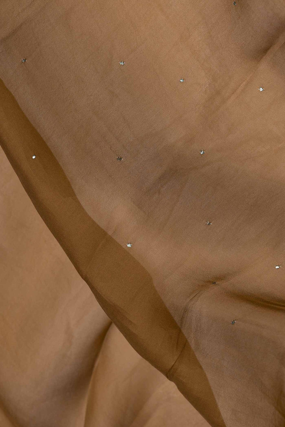 Close up of Bronze Dual Tone Organza Silk Saree with Embroidery on the body and Embroidery Border.  displaying folds