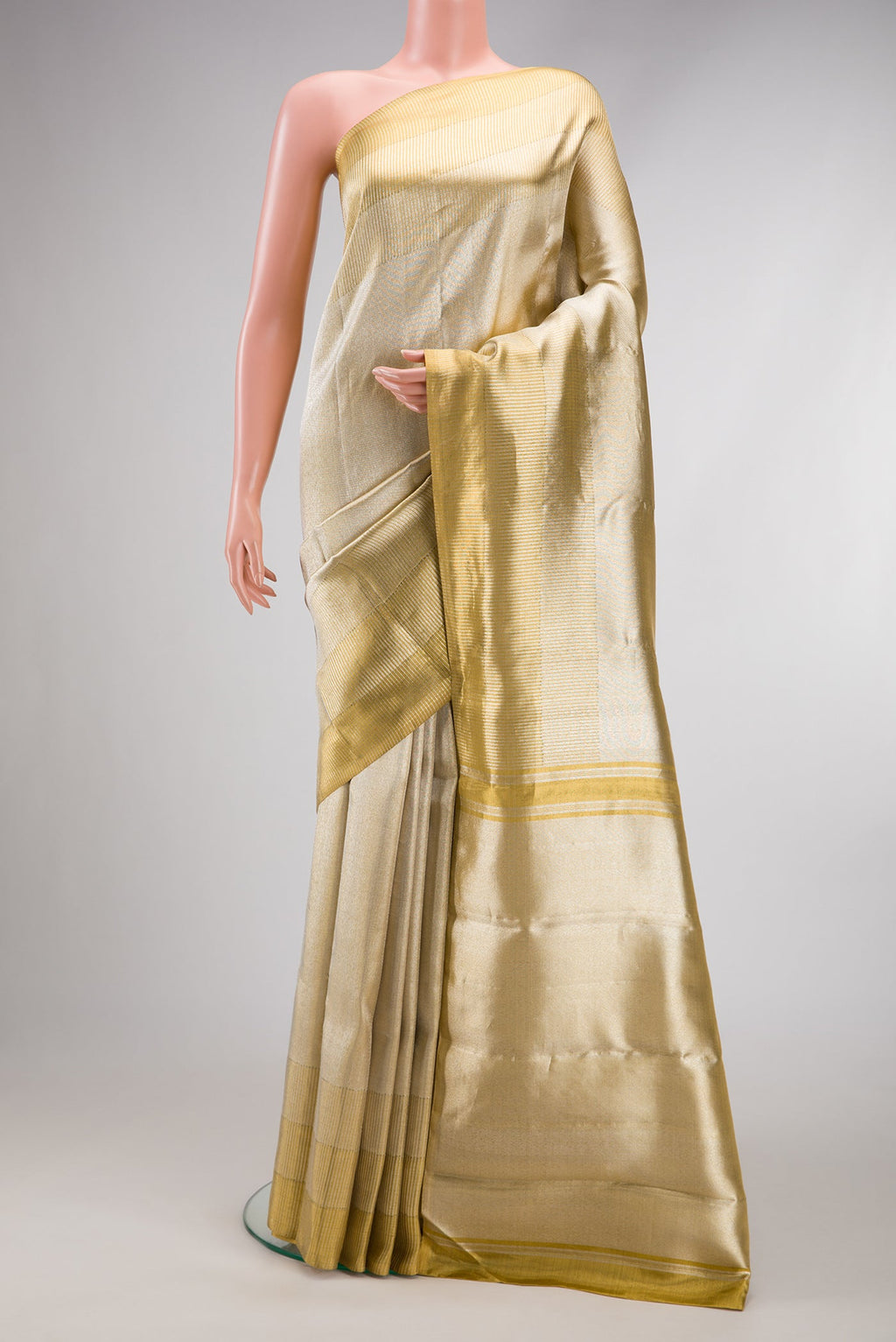 Gold Dual Tone Kanjivaram Tissue Silk Saree with Zari Brocade on the body and Zari Border.  displayed on a mannequin