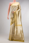 Gold Dual Tone Kanjivaram Tissue Silk Saree with Zari Brocade on the body and Zari Border.  displayed on a mannequin