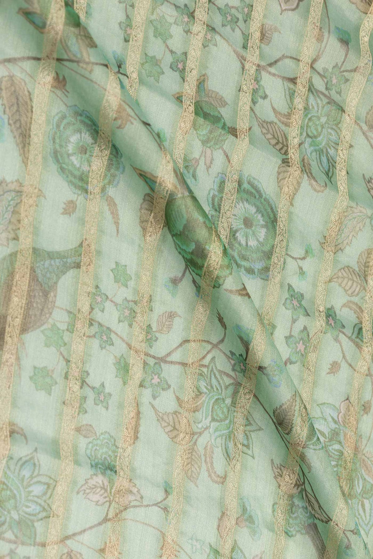 Close up of Green Dual Tone Mysore Georgette Saree with Printed design on the body and Zari Border displaying folds