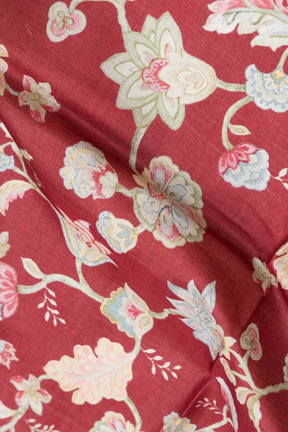 Close up of Maroon Dual Tone Tussar Silk Saree with Printed design on the body and Printed Border.  displaying folds