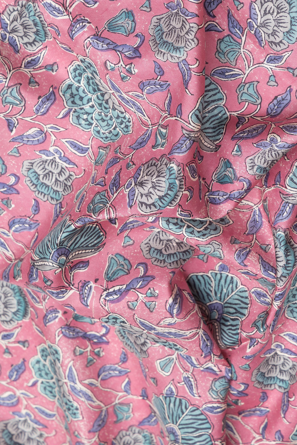 Close up of Pink Printed Silk Saree with Printed design on the body and Zari Border.  displaying folds