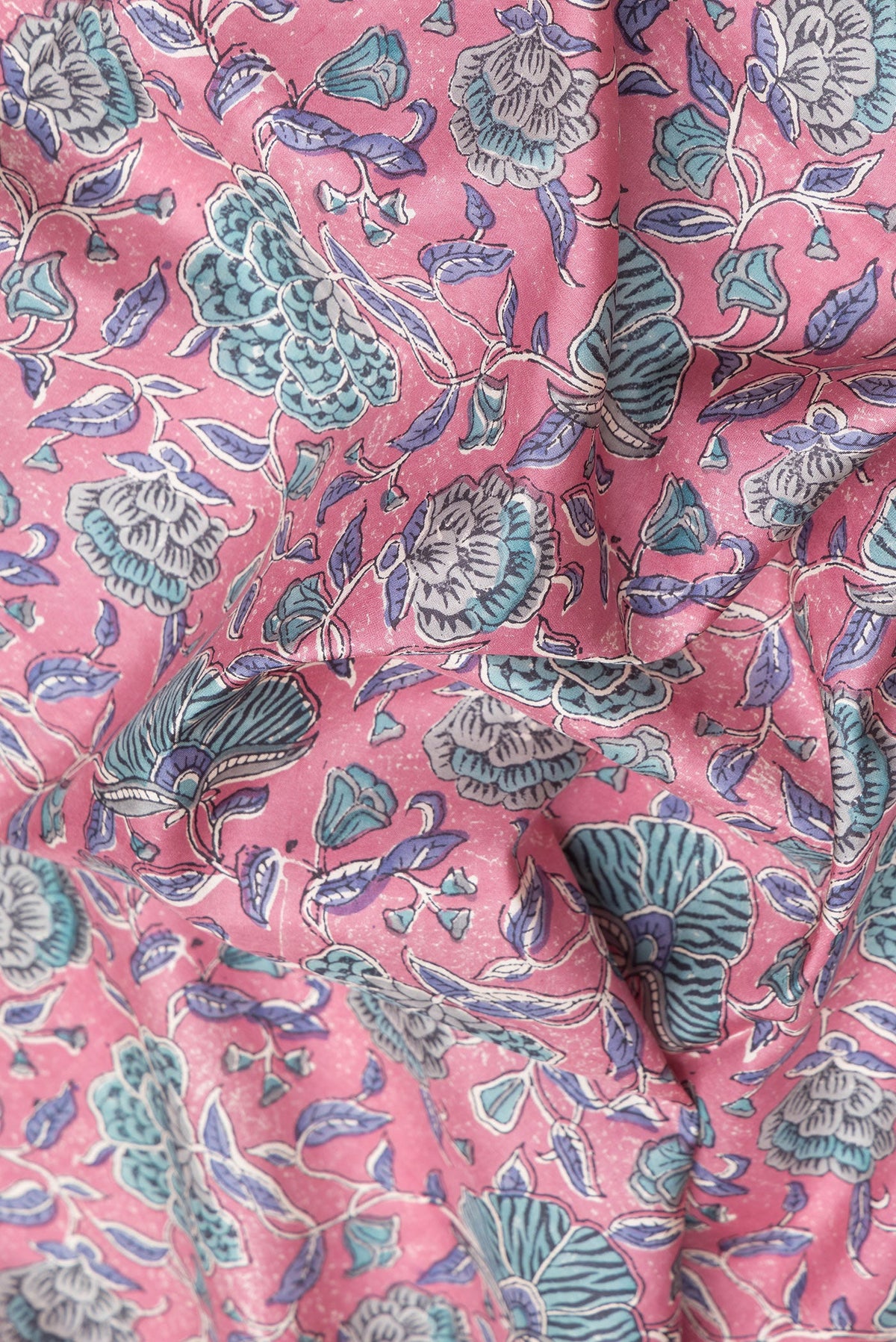 Close up of Pink Printed Silk Saree with Printed design on the body and Zari Border.  displaying folds