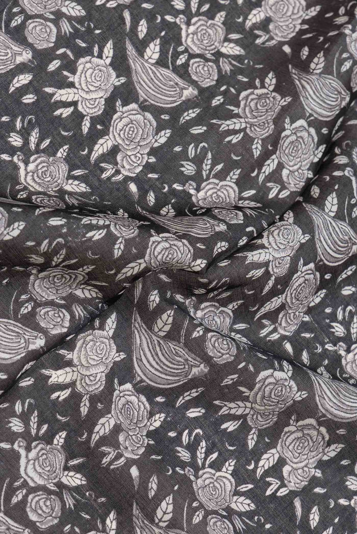 Close up of Black Dual Tone Tussar Silk Saree with Printed design on the body and Embroidery Border.  displaying folds