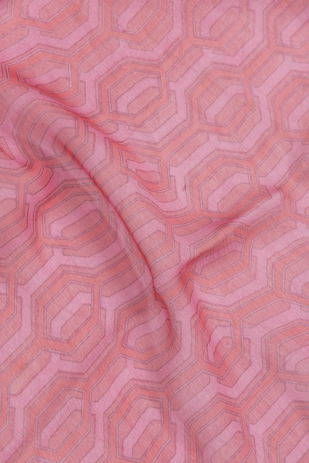 Close up of Pink Dual Tone Mysore Georgette Saree with Printed design on the body and Zari Border.  displaying folds