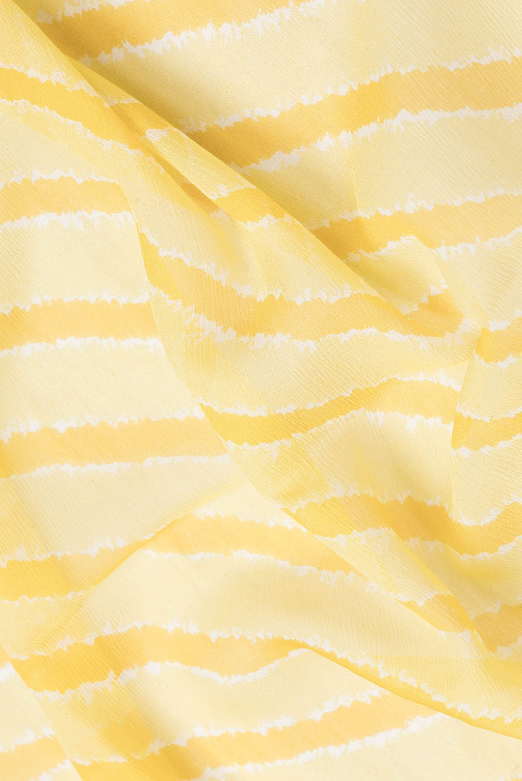 Close up of Yellow Dual Tone Chiffon Saree with Stripes on the body and Zari Border.  displaying folds