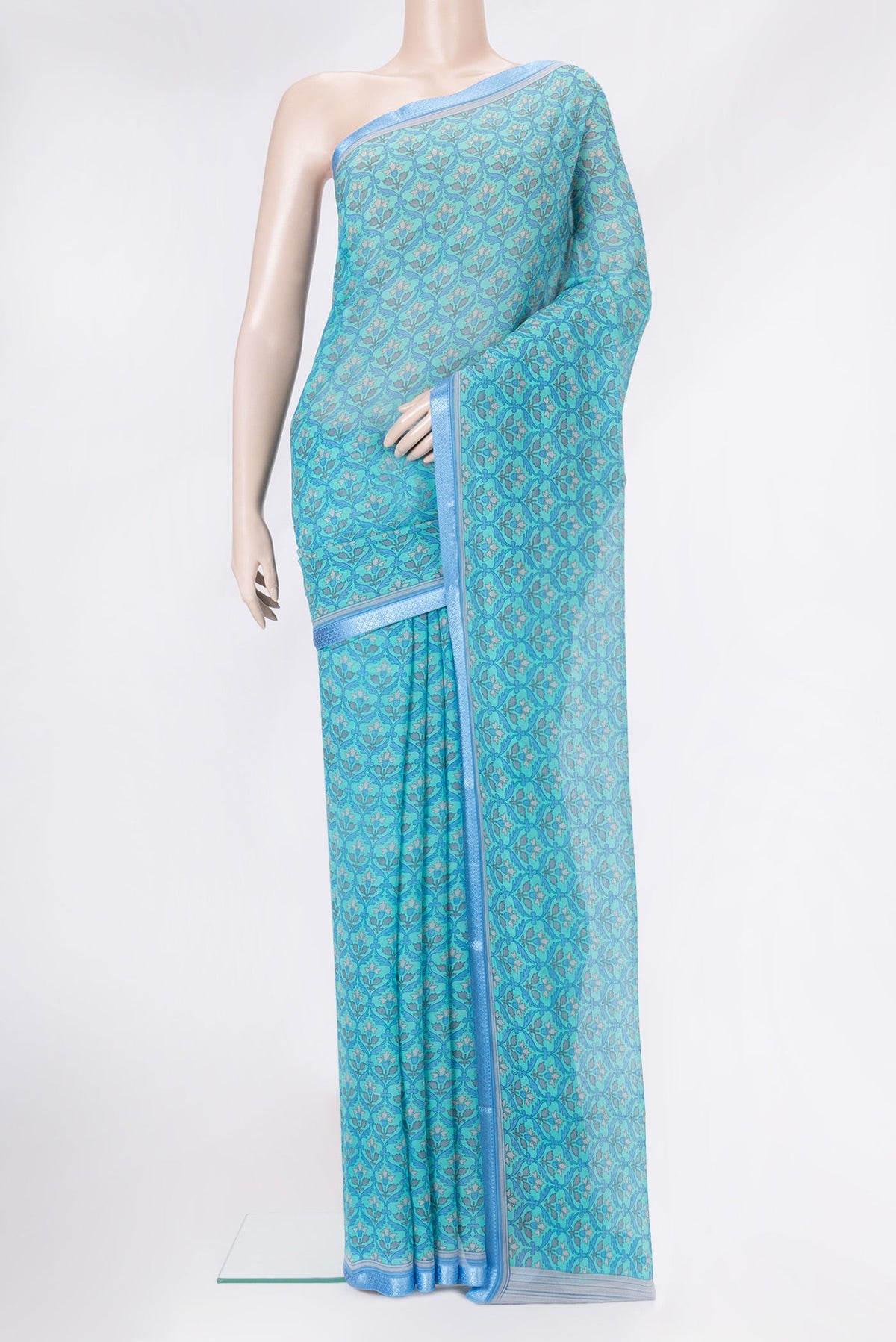 Sky Blue Mysore Chiffon Saree with Printed design on the body and Thread Border.  displayed on a mannequin